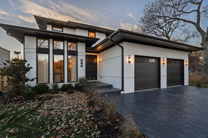 FIRST FLOOR PRIMARY SUITE, new construction home is perfectly located in the center of Glencoe, steps away from top-rated schools, the Metra station, parks, beach, local restaurants and all businesses in town. It is built to last by a local reputable developer. The perfect balance of function, comfort and sophistication! Filled with natural light and high end, best quality, elegant finishes, all real wood custom cabinetry, high ceilings and tall doors throughout the entire house, double paneled, European, tilt-and-turn oversized windows. The first floor primary suite offers a spa-like bathroom, walk-in closet and a comfortable bedroom with a fireplace and garden views. Thoughtfully designed chef's kitchen, the heart of this house, is conveniently equipped with a spacious walk-in pantry and a massive island with lots of storage, adjoining dining area and a family room with gorgeous fireplace framed with unique Jerusalem stone offer comfort and effortless entertaining. Step outside to a beautiful patio with a built-in grill station and lush garden to enjoy al fresco dining during summer months.  Second floor all three en-suite bedrooms are warm and inviting with full bathrooms and walk-in closets. The lower level/basement has heated floors throughout, tall windows and ceilings, a wet bar area, recreation room with best quality real wood built-in furniture and a fireplace, cozy home cinema, full bathroom and bedroom with ample closet for storage. Two full laundry rooms, on the first and second floor, with custom wood cabinetry offering plenty of storage, as well as the mud room with a (versatile) dog washing station or another closet for storage, central vacuum cleaner, 400 - AMP electrical service and beautifully landscaped and gated backyard. Two car heated attached garage with Epoxy floor coating.  540 Green Bay Road is one of a kind  well made new construction  awaiting new owners to become a home!