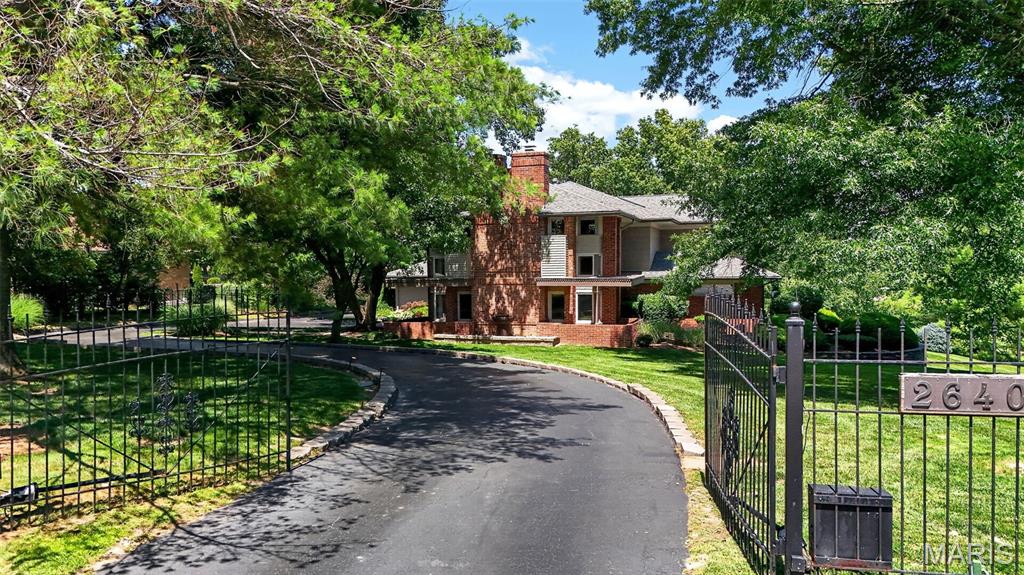 RARE OPPORTUNITY!! Privately Gated, Stunning FRANK LLOYD WRIGHT Design home on ONE ACRE features 3,700+ sq ft and backs up the Forest Hills Country Club 9th Tee Box. This 4 bed, 3.5 bath home blends timeless design with modern upgrades, featuring Wood floors, exposed beams, Gorgeous fireplace, and a bright, open layout. The updated kitchen offers a large island, Stainless Steel Appliances, custom cabinetry, and seamless flow into the main living spaces—perfect for entertaining. The Lower Level has a spa like Bathroom in addition to a brand new sauna. Additional highlights include a dedicated office space on the main level, Main Floor Laundry, wrap around deck with awnings and outdoor kitchen, and spacious 3-car garage with finishes that will blow you away. Surrounded by mature trees and an elevated setting. This is one you will NOT want to Miss!!!