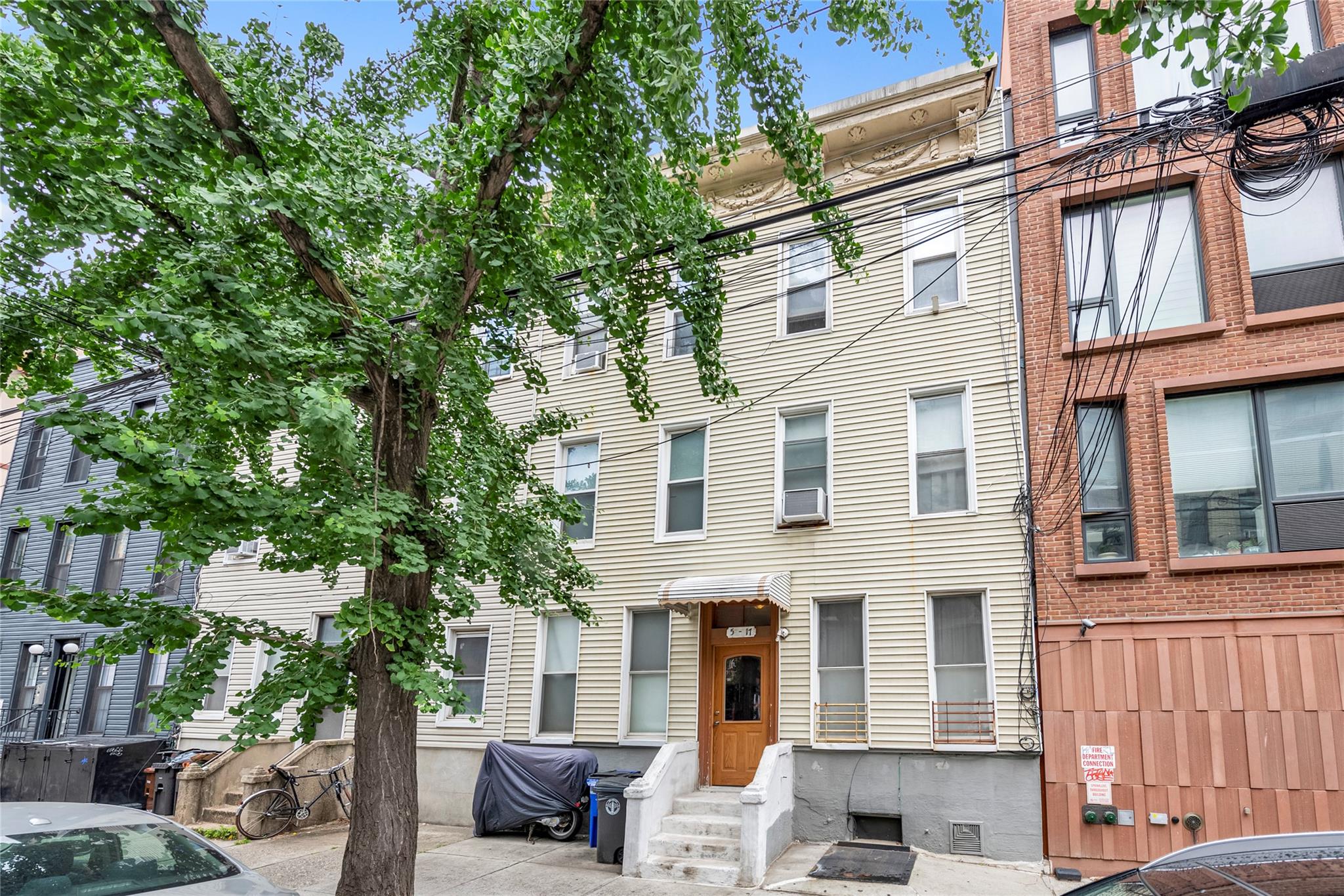 Nestled on a picturesque, tree-lined street in the heart of Long Island City, this classic three-story building offers a rare investment opportunity with six well-maintained one-bedroom, one-bath units. The property includes a spacious basement offering ample storage and potential for future amenities.  Step into the serene backyard and you'll find mature fig trees that create a peaceful urban oasis - perfect for tenants seeing a slice of nature in the city. Located just minutes from major highways, public transportation, and restaurants, this building offers unbeatable connectivity while maintaining a quiet residential feel.
Whether you're looking to expand your investment portfolio or convert to a boutique condo project, this Long Island City gem offers incredible potential in a rapidly growing neighborhood