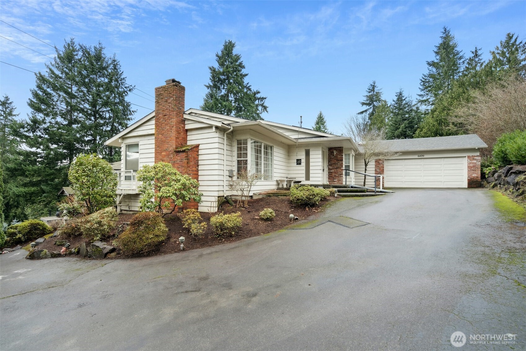 Stunning estate homesite in the heart of Kirkland’s highly sought-after Holmes Point. This exceptional 36,524-square-foot (.84-acre) lot is tucked away on a quiet lane in one of the most tranquil settings in all of Kirkland, featuring an original tennis/sport court and surrounded by towering evergreens and mature landscaping. Permits are nearing issuance for a 4-bedroom, 3.5-bath, 3,229-square-foot architect-designed custom modern home with a 3-car garage and desirable westerly views showcasing rose-colored sunsets and the Olympic Mountains. Extensive permit-related studies and design work have already been completed, significantly streamlining the path to construction—whether you proceed with the current design or reimagine your own vision. The existing 1959 home offers over 4,000 square feet and is considered of minimal value, presenting a rare opportunity to build new in an established estate setting. The property borders over 600 acres of protected forests and parks and is just a short walk to waterfront Denny Park. Enjoy close proximity to the Holmes Point community boat launch, with surrounding new construction homes valued between $3M–$4M. An unparalleled “A+” location—just 10 minutes to historic Inglewood Golf Club and vibrant Juanita Village, and 15 minutes to downtown Kirkland’s shops, dining, and waterfront lifestyle. Don’t miss this opportunity to build your forever dream home in one of the Eastside’s most coveted neighborhoods.