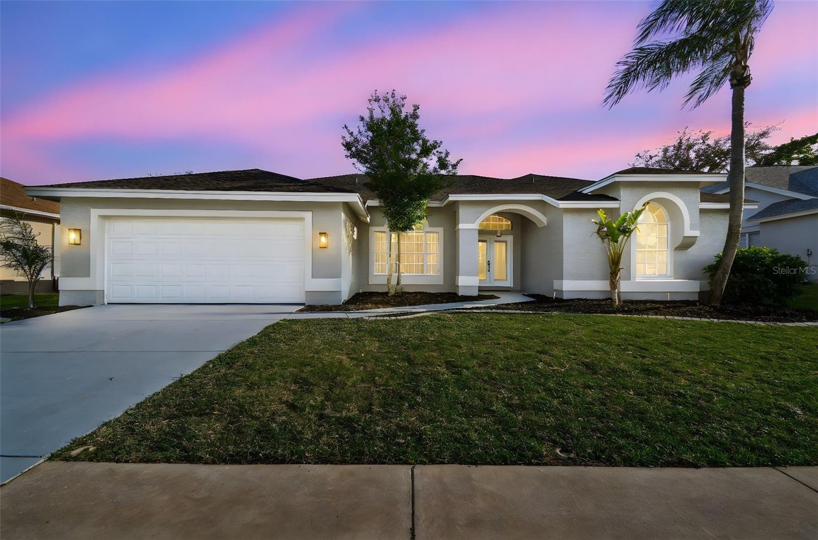Exclusive one of a kind POOL Home in the highly desirable neighborhood of "THE ESTATES" in Hudson. A picturesque golf course community with nature trails strewn throughout the neighborhood, this single story RANCH is now available for sale. Step inside and be impressed by this FULL TOP DOWN RENOVATION making this house feel BRAND NEW. Exquisite TALL CEILINGS and ample natural lighting gives the home a brilliant and aery feel. An appealing grey wood look LVT flooring floats consistently throughout the entire home. A stellar floorplan, one walks into a front entry foyer with open sightlines to the LARGE Living & Dining room combo. The primary suite is located to the right of the entry and is tucked away from the rest of the home making it a perfect place to find some much needed solitude. The primary en-suite has been fully decked out with dual vanity, large soaking tub, POSH walk in shower w/ glass encasement, private water closet and TWO GIANT HIS & HERS CLOSET. Walking past the living room one will enter the Kitchen Family room combo. The GOURMET kitchen is absolutely LUXURIOUS. High end stainless steel appliances, solid wood cabinets and QUARTZ make this the perfect place to cook meals and ENTERTAIN. The kitchen peninsula is a great place to put bar stools overlooking the elegant family room centered around the MODERN FIREPLACE. A powder room, INDOOR LAUNDRY and egress to the OVERSIZED 2 Car Garage w/ NEW EPOXY FLOORING can be found in the hall off the kitchen. Tucked in the back wing of the home are two sizeable bedrooms w/ walk-in closets. They are serviced by a hall bath that doubles up as pool bath with access to the FULLY SCREENED LANAI. The POOL area is a DREAM. Equipped with a covered area, it is the perfect place to set up an outdoor living & entertainment set for those BEAUTIFUL FLORIDA days where we leave all the sliders open. 3 LARGE SLIDERS provide a great vantage point from the house to this surreal OASIS. COLOSSOL and equipped with NEWER POOL Equipment, the POOL is the perfect place to soak and relax. RENO COMPLETED IN 2025- NEW ROOF, NEW WATER HEATER, NEW PAINT THROUGHOUT, NEW FIXTURES, NEW WATER FILTRATION SYSTEM, nearly everything in this home is BRAND NEW! Topping it off, the home has been renovated thoughtfully with high end finishes and neutral colors giving the purchaser the ability to PUT THEIR OWN TOUCHES w/ ENDLESS POSSIBILITIES. Topping it off the HoA takes care of LAWN MAINTENANCE (Mowing, edging & cleanup) and comes with Spectrums TOP internet package...such a value! Solid school zones, easy access to shopping and dining and the peace of mind of knowing nothing needs to be done makes this home THE ONE YOU'VE WAITED FOR. PUT YOUR OFFER IN TODAY!