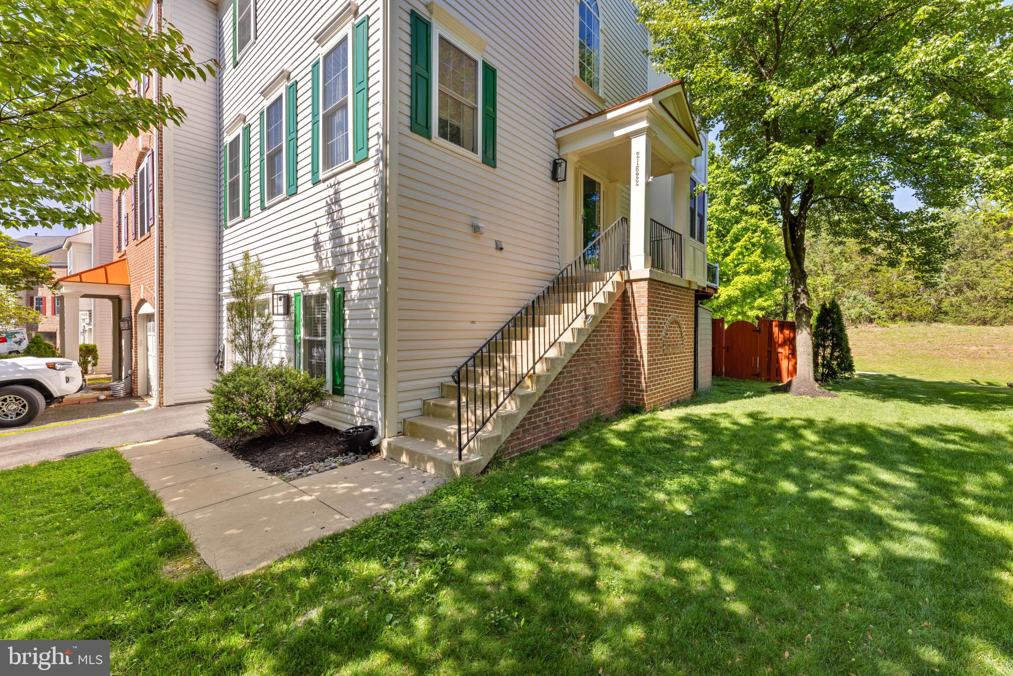 Welcome home to 21622 Monmouth Terrace in the sought after Crossroads Manor Community. Coming to market JUST in time for the 2026 Crossroads Pool season!!  This updated 3 bed, 3.5 bath end unit townhome is the perfect mix of style, comfort, and practicality. Enter through the light filled foyer and up through the open living room towards the refreshed kitchen with updated appliances and exhaust system. Sit down at the oversized island and look out to the private backyard and updated Trex deck. Upstairs you will find all 3 bedrooms with fresh edge to edge paint throughout the entire home. The Primary bathroom, updated in 2025, features a full walk in shower, new glass paneling, updated vanities, and a gorgeous soaking tub. A perfect Spa-like setting in the comfort of your own home. The fully finished walkout basement has a separate full bath for guests, large laundry room with storage, and direct access to the oversized 1 car garage. A fully fenced in back yard leaves yo with plenty of space to play or host a BBQ. With recently updated mechanical systems and  interior design updates (see document section for full update list) 21622 Monmouth is a move in ready, hassle free home awaiting it's new owners!