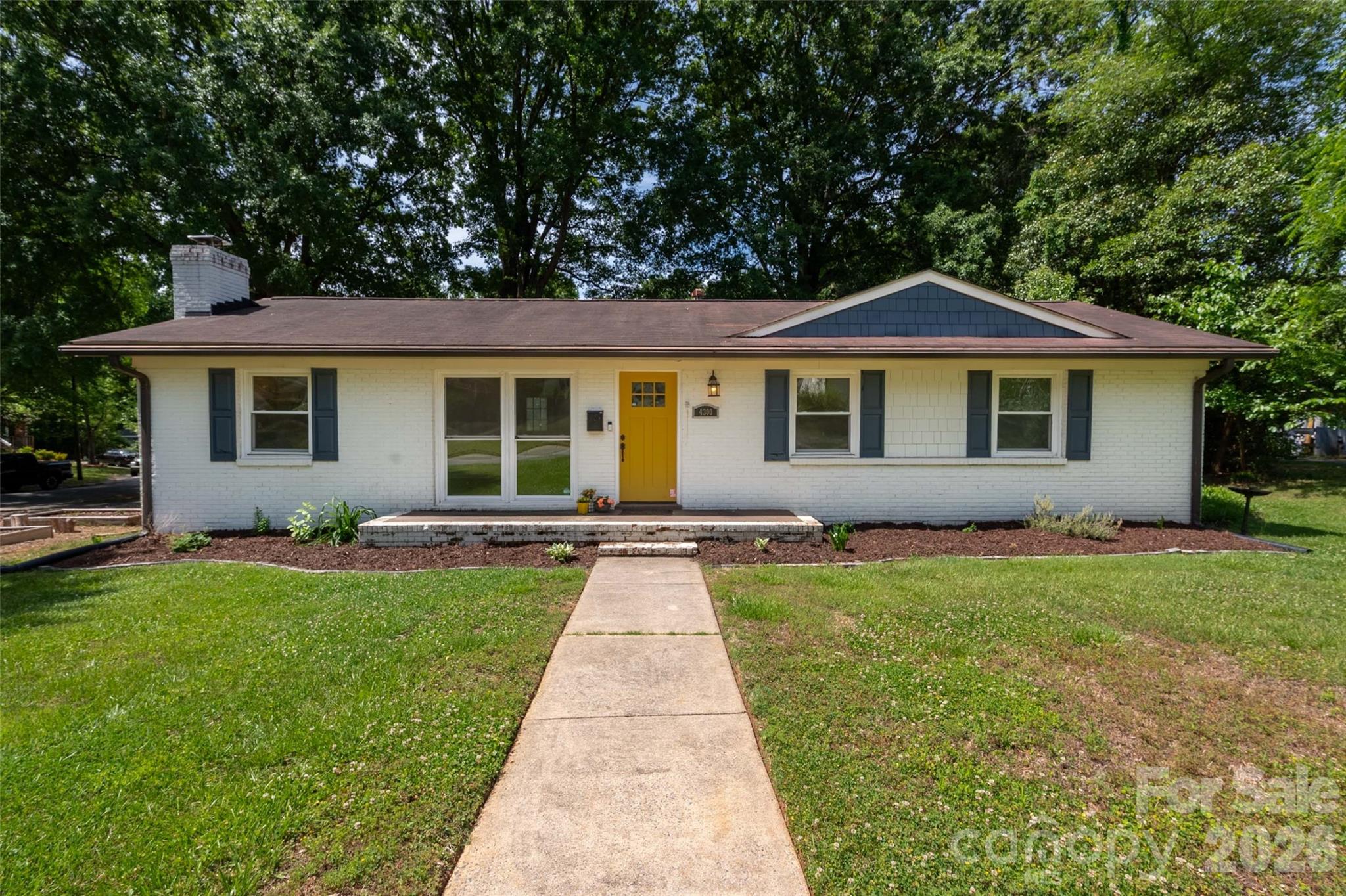 Charming 3 bedroom, 2 full bath brick ranch home on large CORNER LOT in very desirable Windsor Park neighborhood! Open concept with Updated Kitchen featuring stainless steel appliances, quartz countertops and contemporary style cabinets. In the Family Room you'll find a WOOD BURNING FIREPLACE and plenty of room for entertaining friends and family. Beautiful, original solid oak floors throughout the house! Primary Bedroom with Ensuite Bath. Sellers added shelving and cabinet system to one of the two additional bedrooms to make it a perfect Home Office but the space could easily be a nursery or crafting room or returned to it's original purpose. Outside you'll find a LARGE DECK, Firepit, Storage Shed WITH ELECTRICITY, plenty of shelving and additional storage with plenty of cut wood for use in firepit or fireplace (thank you generous sellers!). Close to Plaza Midwood and NODA, easy access to Uptown, many local restaurants and breweries as well as parks and walking/biking trails.