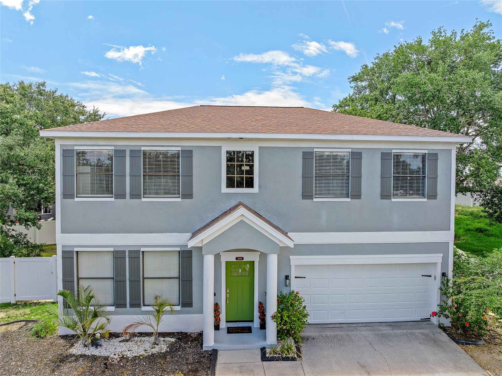 This spacious 2-story home offers 4 bedrooms, 2.5 bathrooms, and approximately 2,589 square feet of thoughtfully designed living space.  Step inside to soaring ceilings and an inviting open floor plan that flows seamlessly from formal living and dining areas to a generous family room. The updated kitchen features granite counters, tile backsplash, and stainless-steel appliances, perfect for everyday living or entertaining guests.  The upstairs primary suite is your private retreat, complete with a large walk-in closet, dual sinks with granite counters, a soaking tub, and a separate shower stall. A versatile loft area provides ideal space for an office, play area, or media room. Enjoy the convenience of indoor laundry, a 2-car attached garage, and a fully fenced oversized lot offering endless possibilities for outdoor living and entertaining. Recent upgrades include a newer roof (2019), dual HVAC systems (2018), water heater (2019), and water softener (2018).  Located just minutes from local parks, community amenities including a boat ramp and water access, and the charming shops and dining of downtown Tarpon Springs, this home blends comfort, function, and Florida lifestyle living.