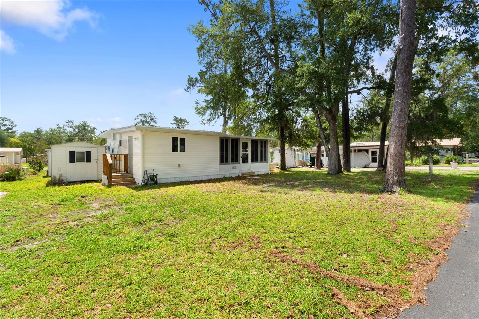 Welcome to Campers Holiday, a peaceful 55+ gated community surrounded by mature trees, natural beauty, and tranquil scenery, while still being just minutes from everything Brooksville has to offer. Unit C-52 features a well-maintained 2-bedroom home with an open kitchen layout, spacious sunroom, and large storage shed. The home was remodeled in 2021 and has been recently pressure washed and professionally cleaned-- making it truly move-in ready. Residents enjoy an impressive list of amenities including complimentary internet and cable TV, a geothermal Olympic-sized swimming pool, recreational hall with library, pool table, stage, and scheduled community activities, outdoor pavilion, fire pits, shuffleboard courts, playground, and access to Sparkman Lake for fishing, boating, and relaxing by the water. Don't miss this opportunity to own an affordable seasonal getaway or full-time residence in one of Hernando County's most peaceful and welcoming communities. Call today to schedule your private showing!