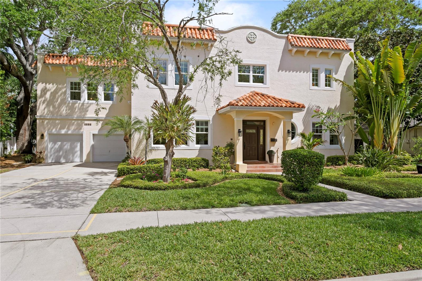 Under contract-accepting backup offers. Virtually Staged. An Unrepeatable South Tampa Sanctuary - Offering the peace of mind that only custom all-block construction can provide, this modern Mediterranean pool home stands as a rare, turnkey alternative to new construction. Situated in a highly coveted NO FLOOD ZONE (X Zone) in the Palma Ceia West/Virginia Park area, this high-and-dry estate rests on an oversized, lushly landscaped 100x100 lot—a footprint virtually impossible to replicate in today’s market.Inside, architectural integrity meets elevated luxury. Soaring 10-foot ceilings, solid core doors, rich crown molding, Venetian plaster accents, and warm hardwood floors establish an atmosphere of timeless permanence. The grand entryway is flanked by a flexible executive office/library and a formal dining space that opens to a temperature-controlled, 800+ bottle wine room designed for the true collector.At the heart of the residence, a refreshed gourmet chef’s kitchen boasts bespoke cabinetry, granite surfaces, double ovens, refrigerated drawers, and a pro-series Wolf gas cooktop. The adjacent light-filled family room is anchored by a custom fireplace, with French doors yielding to an incredible outdoor living retreat—complete with a large covered lanai, built-in firepit lounge, and a heated saltwater pool and spa framed by mature, tropical shade trees.Upstairs, the primary suite serves as a true sanctuary, featuring double walk-in closets, a spa-like ensuite bath, and a private “Juliet Balcony." A separate, sunlit in-law/guest suite offers incredible versatility with its own extended private terrace, full bath, and adjoining flex space. With fresh interior paint, updated designer lighting and fans, an oversized epoxy-finished garage, extended driveway for off-street parking, and immediate walkability to top-rated public & private schools, sun-dappled parks, grocery stores, Michelin-acclaimed dining, and premier shopping, as well as rapid access to Downtown Tampa and TIA airport, this residence represents an irreplaceable opportunity to own high-end quality in South Tampa's most desirable enclave.