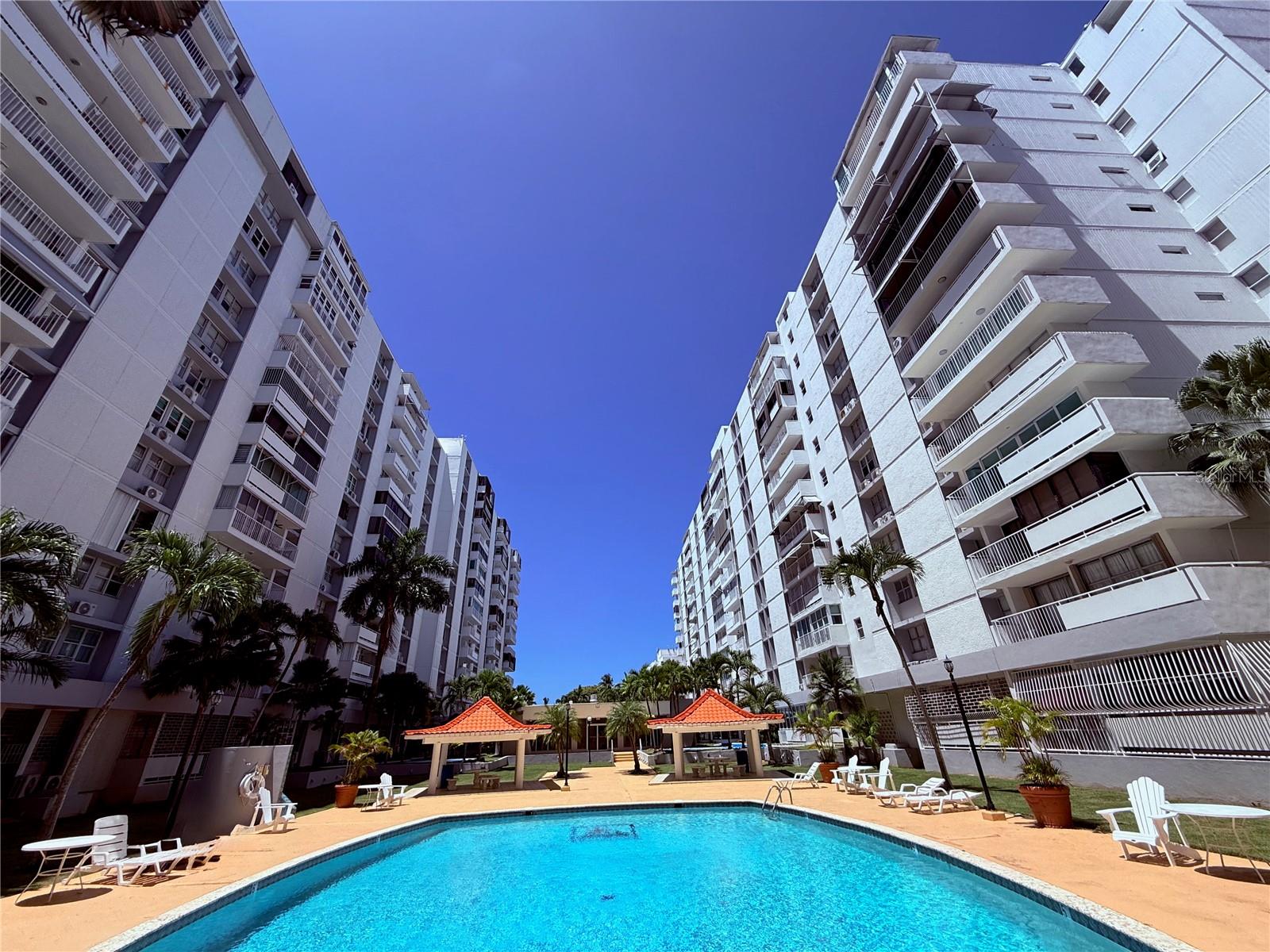 High-Floor Corner Residence | Isla Verde !Enjoy stunning ocean and city views from this high-floor corner apartment, ideally located in one of Isla Verde’s most desirable residential condominiums. Short-term rentals are not permitted, ensuring a peaceful residential environment.This spacious residence features an open-concept layout with a bright living and dining area, a fully equipped kitchen with stainless steel appliances, 3 bedrooms, and 2 full bathrooms. The unit includes washer and dryer, tile floors, split A/C units in every room, window curtains, and lighting fixtures, offering both comfort and convenience.Just steps from Isla Verde Beach, and directly across from the Fairmont El San Juan Hotel and The Royal Sonesta San Juan, this property is also minutes from top restaurants, shopping, hotels, and entertainment, offering the ideal balance between beachfront serenity and vibrant city living. Building Amenities24/7 security & gated access, Swimming pool,Fitness center, Elegant lobby,,Tropical gardensWater cistern Full power generator for common areas. 1 covered parking space + 1 (first-come, first-served)