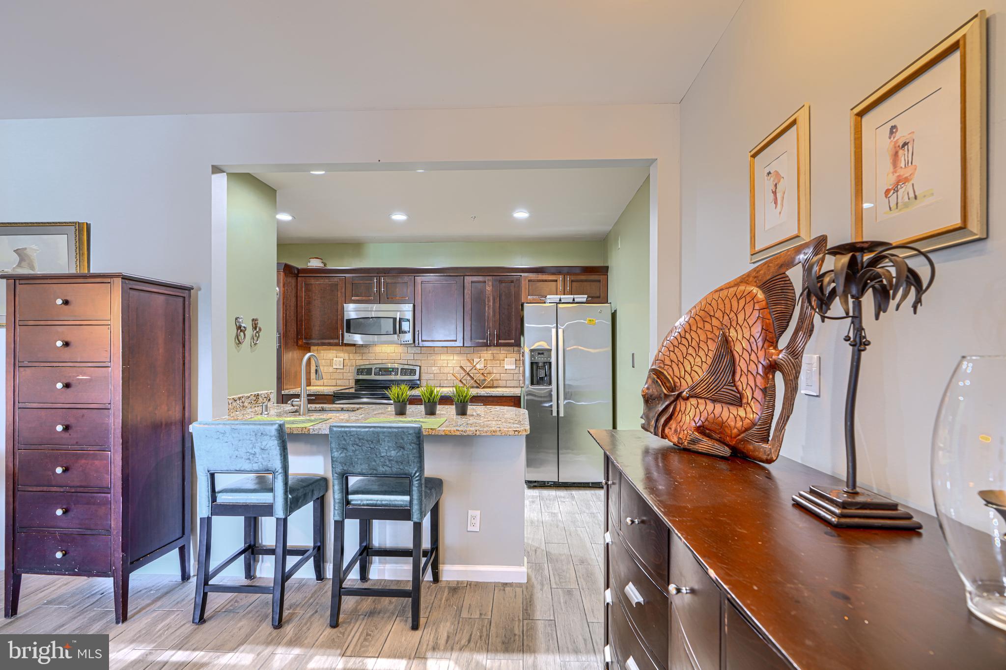 Rarely available two-story waterfront penthouse condominium in Henderson's Wharf, located in the heart of historic Fells Point. This spacious residence offers soaring vaulted ceilings, an open and light-filled layout, and spectacular harbor and city skyline views from an oversized private balcony.The dramatic two-sided fireplace creates a warm focal point between the living spaces, while the unique two-level floor plan provides both comfort and privacy. The lower level features a spacious bedroom and 1.5 bathrooms. Upstairs, you'll find the kitchen, living and dining areas, fireplace, and direct access to the expansive balcony overlooking the waterfront.This condominium includes a deeded garage parking space (#140 on the second level) with a private storage unit. Residents of Henderson's Wharf enjoy exceptional amenities, including 24-hour concierge service, a 24-hour fitness center, beautifully maintained common areas, and secure garage parking.Perfectly positioned along Baltimore's waterfront, this home is just steps from Fells Point's award-winning restaurants, waterfront promenade, water taxi, Whole Foods, Harbor East, and downtown. Experience the best of waterfront city living in one of Baltimore's most desirable neighborhoods.