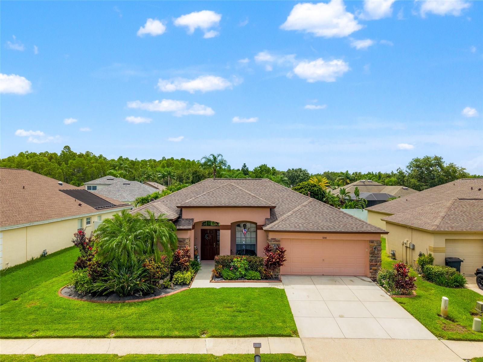 Welcome to your dream retreat in a beautiful gated community! This spacious 4-bedroom, 3-bath home offers a thoughtfully designed split-bedroom layout and a welcoming open-concept family room and kitchen—perfect for gatherings and everyday living. The kitchen boasts abundant cabinetry, a gas range, a breakfast bar, and a sunny dinette area with sliding glass doors opening to the covered lanai.
The luxurious primary suite features double closets, an en suite bath with a garden tub, a separate shower, and dual vanity areas for added convenience. Step directly from the suite to the lanai and unwind in your private spa—an ideal spot to soak away the day.
Two additional bedrooms and a full bath are tucked away on one side of the home, while a fourth bedroom and another full bath at the rear offer privacy and access to the fully fenced backyard.
Framed by lush, resort-style landscaping, this home brings a vacation vibe to everyday life. Community amenities are just moments away, offering a vibrant and active lifestyle.
Don’t miss this opportunity—make this inviting residence your new home today.