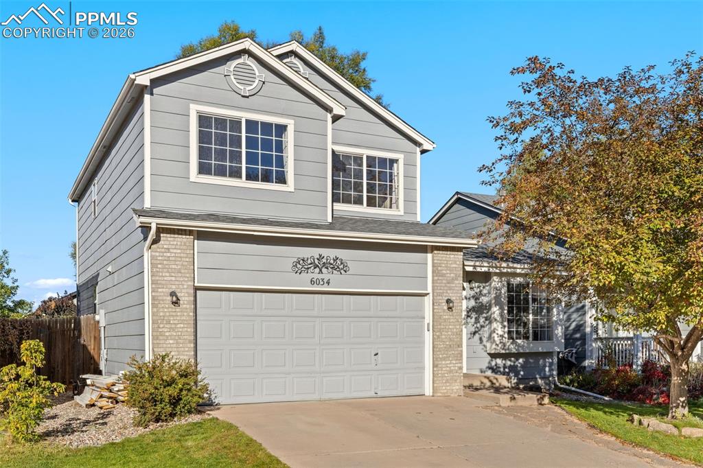 Nestled in the established Sundown neighborhood and just a short walk to Fred McKown Park, with shopping, dining, and everyday conveniences minutes away, this inviting two-story home blends comfort, character, and thoughtful updates. Tree-lined streets and mature landscaping create a welcoming first impression before you even step inside. The home opens to tile flooring that transitions to newer carpet and a warm, welcoming living room featuring a built-in window bench; perfect place for morning coffee, quiet reading, or simply enjoying the natural light — all framed by a vaulted ceiling with decorative display shelf that enhances the home’s airy feel. Stylish two-sided fireplace with subway tile and stone hearth serves as a beautiful focal point while seamlessly connecting the living room to great room. Here, built-in shelving, a ceiling fan, and expansive windows showcase mature trees and backyard views, creating a space that feels both open and comfortably grounded. Dining area opens directly to a concrete patio ideal for summer evenings, barbecues, and indoor-outdoor entertaining. The kitchen stands out with striking raw-edge granite countertop, under-mount sink, white cabinetry, SS appliances, pantry, and durable tile flooring — balancing style with function. Convenient coat closet and well-appointed half bath with granite vanity complete the main level. Upstairs, two secondary bedrooms with ceiling fans offer flexibility for family or a home office and share an updated full bath. Spacious primary suite captures beautiful Pikes Peak and mountain views and features a walk-in closet with a refreshed bath showcasing a raised vanity, under-mount sink, medicine cabinet, and tile flooring. Basement provides flex space perfect for a media area, workout zone, playroom, plus crawl space storage and a large utility/laundry room with sink and rough-in for a bathroom. Major upgrades including newer furnace, A/C, blue-light filter, and humidifier for year-round comfort.