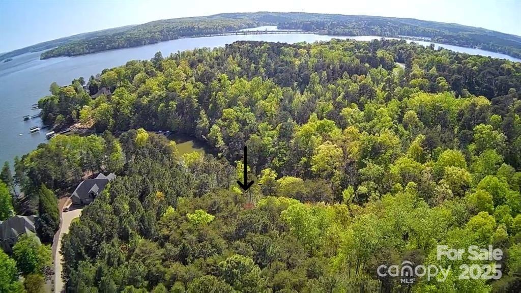 This Badin Lake waterfront lot is located in the prestigious gated community of Heron Bay. Great location near the clubhouse. 1.0 acre lot. The southern lot line has been recently marked by a surveyor. Deeded boat slip included on Marina/Dock C at the Clubhouse: Boat Slip # C-7. Ask Listing Office about the opportunity to purchase the adjacent property. The neighborhood includes a club house, paved boat ramp, boat slips, walking trails, and boat/RV storage. Heron Bay owners have the opportunity to join the adjacent Old North State Country Club. The Old North State Club offers a highly rated golf course, marina, club house, restaurant, pool, tennis courts, and more. Club opportunities require membership. Badin Lake has marinas that provide dining, gas & watercraft rental. The Uwharrie National Forest nearby is a great destination for camping, hiking, horseback riding, and ATV/OHV trails. Within one hour from Charlotte, Greensboro & Winston-Salem. Look for the for sale sign by the road.