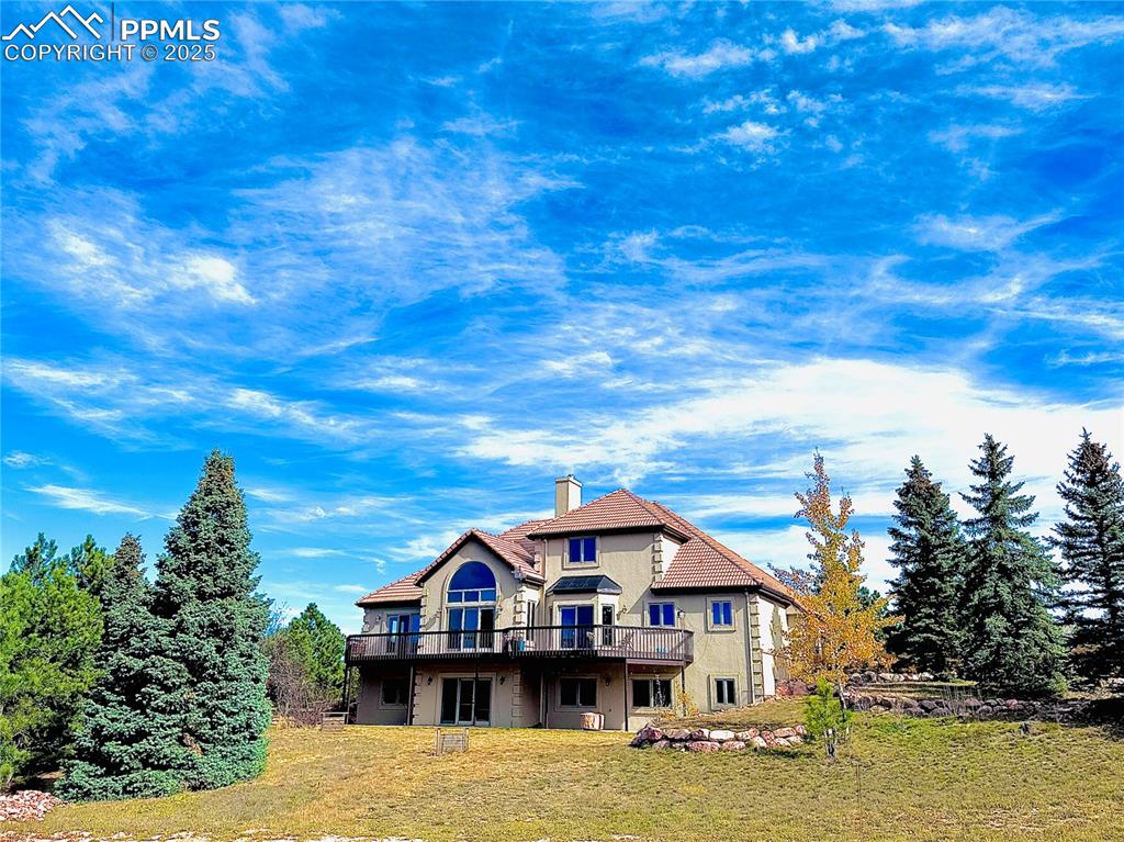 UPDATES! Welcome to your 2.5 acre oasis, with new stucco and soon new composite shingle roof, nestled on a private, treed lot with magnificent views of the mountains! This 2 story home offers a main level primary bedroom (access to the rear deck) with an attached 5-piece bath (heated floors) and walk-in closet. Head upstairs to the 2 bedrooms w/a jack-and-jill bath AND a super cute loft between the bedrooms that could be used as a toy/play/lounging area. The main level also boasts a very spacious carpeted office near the front door and a lovely formal dining room w/access to the dry bar and kitchen. In the eat-in kitchen you'll find a 2-sided fireplace, room for a kitchen table, island with stovetop, and the flexibility to walk out to the elongated deck to enjoy the majestic views of Pikes Peak. Head downstairs to the unfinished, 2000 s.f. walk-out basement to see the endless possibilities. You won’t want to miss this gem of a home located in D-38!