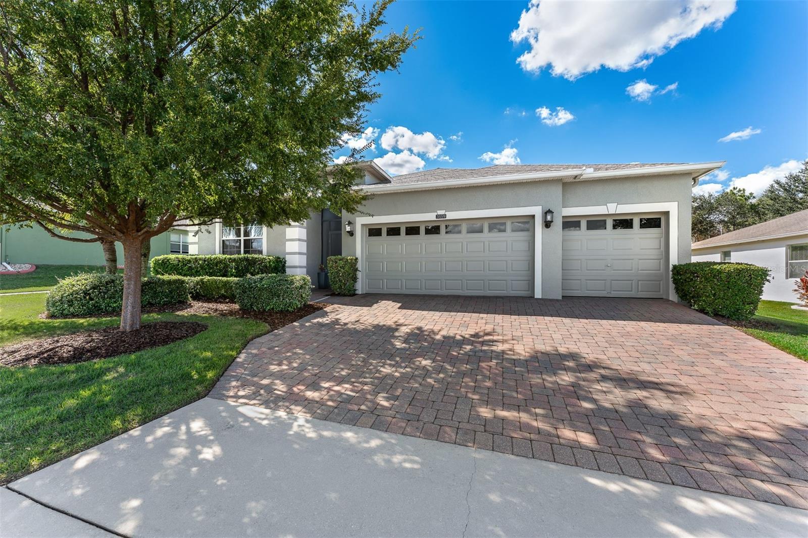 Welcome to 3859 Sanibel Street! Discover comfort, space, and resort-style living in this beautifully maintained home with no rear neighbors in the desirable Heritage Hills 55+ gated community in Clermont, Florida. Built in 2014, this popular Monroe II model offers 3 bedrooms, 3 full bathrooms, a private office with French doors, a three-car garage with overhead storage racks, and 2,554 sq. ft. of living space. The open floor plan combines the kitchen, family room, and breakfast nook, complemented by a formal living and dining room combination and two primary suites, ideal for guests or multigenerational living. Recent improvements include freshly painted interior and exterior walls, updated foyer and dining room lighting, a freshly painted garage floor, professional cleaning, and a pressure-washed driveway. Step inside and you'll immediately appreciate the welcoming atmosphere and spacious foyer which leads to a guest bedroom near a full bathroom. Continue down the hallway to discover the versatile private office, complete with French doors. Whether you work from home, enjoy hobbies, or simply need a quiet space to unwind, this room offers endless possibilities.  The formal living and dining room combination provides an inviting space for gatherings and special occasions. The kitchen features granite countertops, stainless steel appliances, a breakfast bar, pendant lighting, and a pantry. The adjoining breakfast nook overlooks the natural light-filled living space. The family room opens through sliding glass doors to the extended, screened-in lanai with an awning, perfect for relaxing or entertaining. The private primary suite features two oversized walk-in closets and an en-suite bathroom with dual sinks, upgraded faucets, a stone countertop, and a large walk-in shower with several handrails. The second primary suite includes its own private bathroom, offering comfort and privacy for guests. Additional features include tile flooring in the main living areas, luxury vinyl flooring in all bedrooms, and ceiling fans in all bedrooms, the family room, office, and lanai. Enjoy an excellent location within the community! Situated in the Tripoli subdivision, the home offers convenient access to the main entrance and Hancock Road, as well as the impressive 19,000-square-foot clubhouse. Heritage Hills offers 24-hour manned gated security, a fitness center, resort-style pool and spa, tennis and pickleball courts, bocce ball, shuffleboard, walking trails, and a variety of social activities and community events. The HOA assessment currently includes lawn maintenance, Spectrum cable and high-speed internet, exterior maintenance, and reserves for exterior painting on a six-year cycle. Buyers should verify current HOA fees, services, and inclusions. Conveniently located near shopping, restaurants, medical facilities, major roadways, Downtown Clermont, lakes, Lake Louisa State Park, the Florida Citrus Tower, and Lakeridge Winery. Golf enthusiats will appreciate the proximity to at least 4 major golf properties.  Orlando, Walt Disney World, and Orlando International Airport are also within convenient driving distance. Enjoy a spacious, well-maintained home, a private outdoor retreat, and the active adult lifestyle that makes Heritage Hills so desirable. Schedule your private showing today!