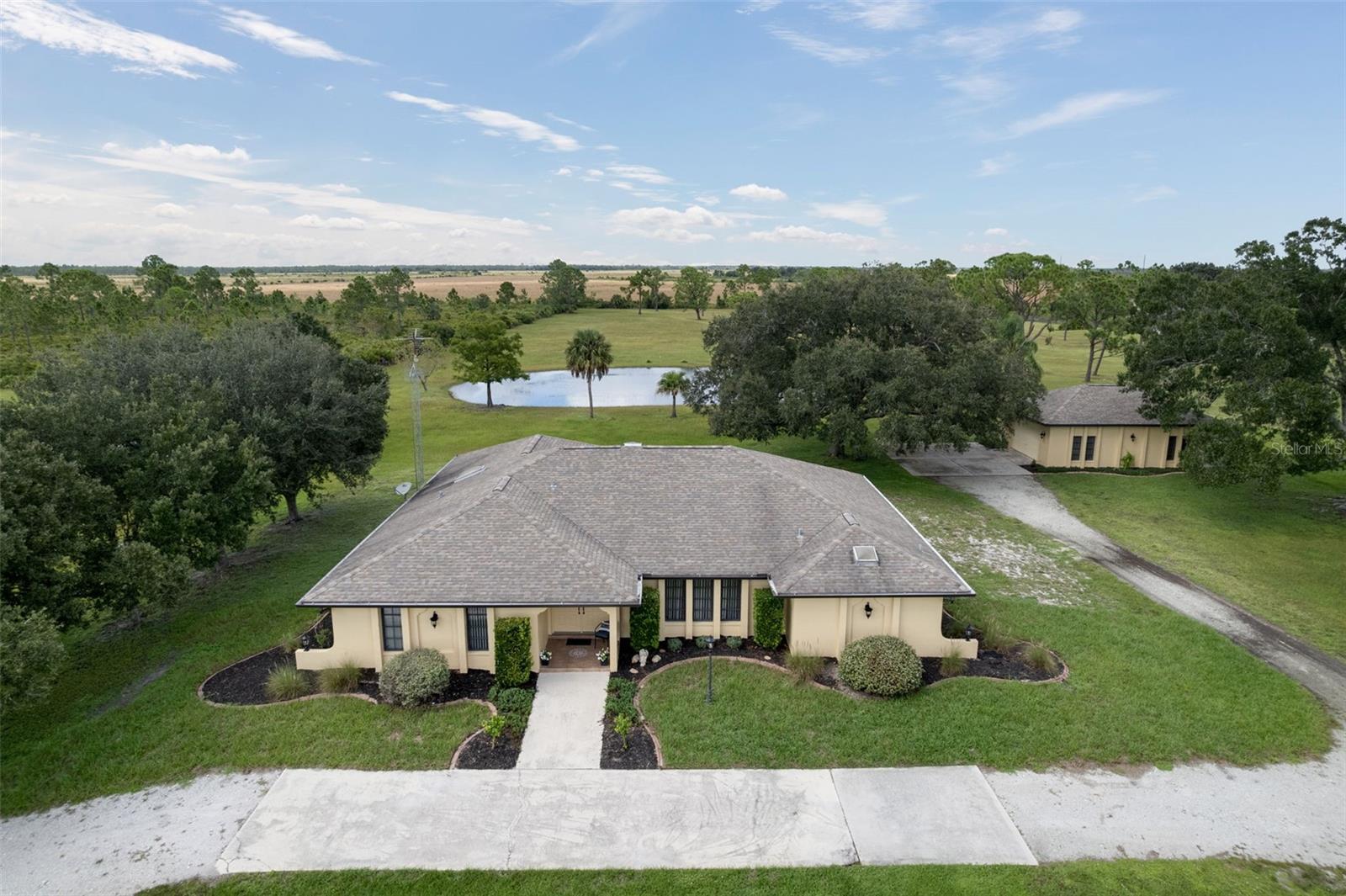 WELCOME TO YOUR PRIVATE COUNTRY RETREAT IN PRAIRIE CREEK PARK! Situated on approximately 5.59 acres, this spacious 4-bedroom (1 ensuite), 3-bath pool home offers approximately 2,579 square feet of living space and the privacy, space, and peaceful surroundings that are increasingly hard to find. The expansive homesite creates a wonderful sense of privacy, while the swimming pool offers the perfect place to relax, entertain, and enjoy the beautiful weather.  The community features access to 15 miles of maintained, rural riding trails situated around the beautiful countryside.Inside, the generous floor plan provides plenty of space for everyday living and entertaining, with four bedrooms (one ensuite) and three full baths (pool bath) offering flexibility for family and guests.  The 4- car garage can be used for storage, boat, Golf cart, workshop or that car enthusiast!  The current owner built the home with her family, enjoying many years of laughter and love.  Enjoy the tranquility of country living while still being within reach of Punta Gorda’s shopping, dining, recreation, and amenities. If you’ve been searching for acreage, privacy, a pool, and room to make a property your own, 17800 Wood Path Court is one you won’t want to miss!