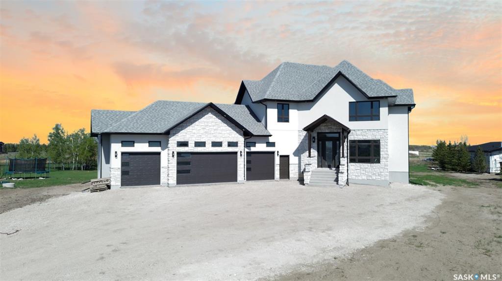 Welcome to this magnificently large and luxurious home in Edgemont Park Estates, one of the Saskatoon area's most exclusive and desirable acreage communities only a few minutes south of the city. Exquisite executive features abound inside and out with 2,837 square feet of living space above grade, an attached 4-car heated garage, plus a completely finished basement. With five bedrooms and six bathrooms, it's the perfect fit for a large family, boasting ample capacity for multigenerational, extended family, or those who enjoy hosting and entertaining guests. The main floor has an impressive living room with a soaring second-floor ceiling and an open-concept kitchen, dining area, and family room. The chef-worthy primary kitchen has custom cabinets with ceiling-high upper cabinets and high-end appliances, and is complemented by a second kitchen for food prep and spicy cooking. The upper level includes three generously sized bedrooms, three ensuite bathrooms, and two balconies for outdoor relaxation. The lower level offers a family room theatre, bar area, and two more bedrooms and full bathrooms. Upgrades include gorgeous engineered hardwood and tile floors, intricate finishing details, central air conditioning, an insulated exterior acrylic stucco system, 10 foot main floor walls, 9 foot 2nd floor and basement walls, and much more. Other wonderful features include main floor laundry, a massive covered deck, and a rear-facing overhead door. Ready for immediate possession, call now for more information or your own private preview.