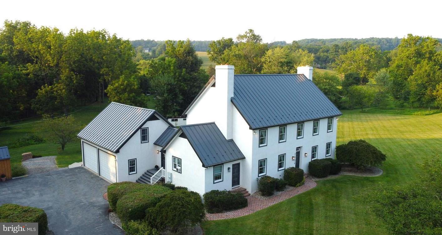 Welcome to your private Chester County home, located on 2 serene acres. Expansive 3,000+square foot home offering multi-generational / in-law quarters along with the outdoor oasis of aninground pool. Home offers space, versatility, and exceptional amenities for today’s lifestyle.Step inside to a welcoming sitting room—ideal as a home office or cozy retreat—complete witha convenient half bath. The home flows seamlessly into a spacious kitchen featuring beautifulwooden cabinetry, abundant storage, generous counter space, and a counter seating area. Thelarge eat-in kitchen is warm and inviting, highlighted by a stunning stone fireplace that createsthe perfect gathering space.The oversized living room boasts a second impressive stone fireplace, abundant natural light, anddoors that open to the full-length deck—ideal for indoor-outdoor entertaining. A formal diningroom provides the perfect setting for hosting holidays and special occasions, along with anadditional powder room on the main level for added convenience.Upstairs, you’ll find three generously sized bedrooms. The primary suite is a true retreat,featuring a walk-in closet and a luxurious ensuite bath with a double vanity, large tiled walk-inshower, and a beautiful soaking tub. Two additional bedrooms share a full hall bath.The lower level offers a flexible living space perfect for a recreation room, home gym, oradditional entertaining area, with doors leading directly to the backyard and in-ground pool.One of the standout features of this property is the private multi-generational/in-law suite locatedon the main level. This separate living area includes its own kitchen with stove, cabinets, andsink, a comfortable living space with ample storage, and a full bath—ideal for extended family &guests.Step outside to your own private retreat. A stunning full-length deck overlooks the in-groundpool and leads down to a beautifully designed pool area complete with a paver patio, outdoorentertaining bar, storage for pool equipment, and full fencing for privacy and peace of mind.Additional highlights include hardwood floors throughout, a durable metal roof, and thetranquility of country living—all while being conveniently located within Chester County.This exceptional property truly has it all—space, flexibility, and an outdoor lifestyle designed formaking memories.