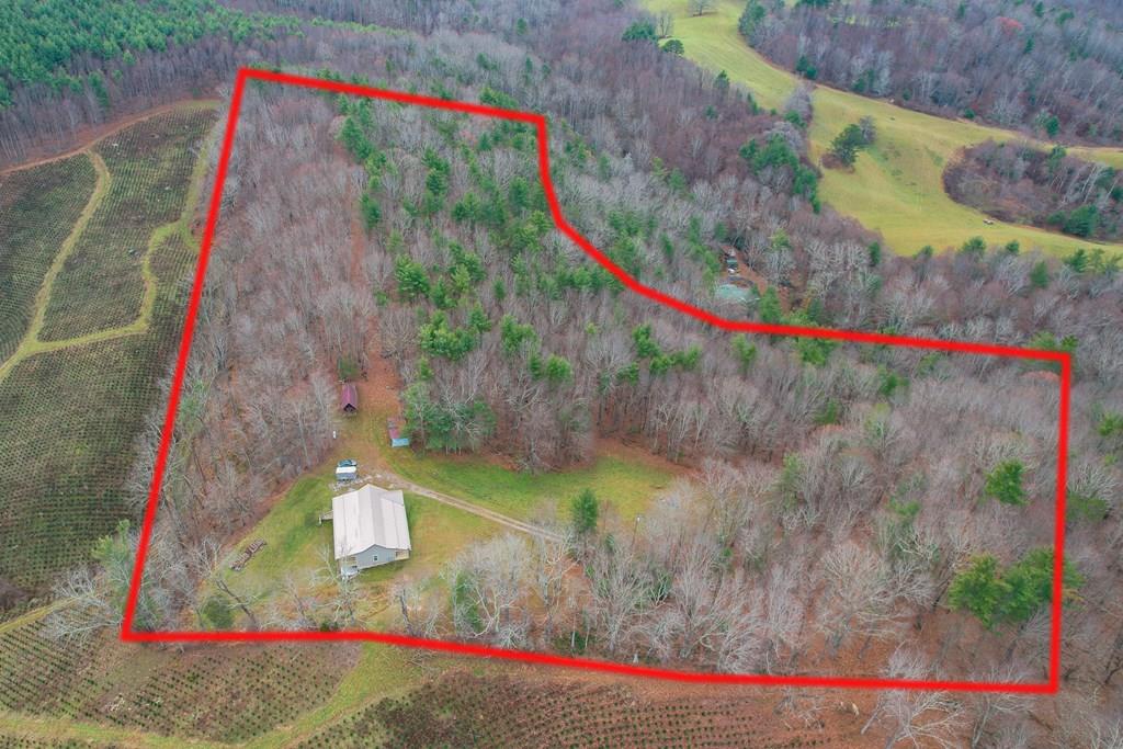 Breathtaking long range views from this newly built home. Acreage features these views in multiple spots.  It is equipped with an automatic generator, commercial-grade flooring, and a state-of-the-art water system that allows for selective shutoff to different areas of the home. On the property there is a shed formerly used for skinning deer that highlights the property's abundant wildlife. The living room features built-in speakers for a superior audio experience. Thoughtfully designed for ease of living, the home includes a waist-high dishwasher, self-closing cabinet doors, and a whole-house vacuum system. The first-floor laundry features a built-in drying rack and ironing board. The home offers both a home office and a man cave as well. Additional living room and bedroom downstairs, this property provides the perfect balance of luxury, functionality, and tranquility. Perfect land to hunt on. Near multiple hiking trails in the area. Come see it today!