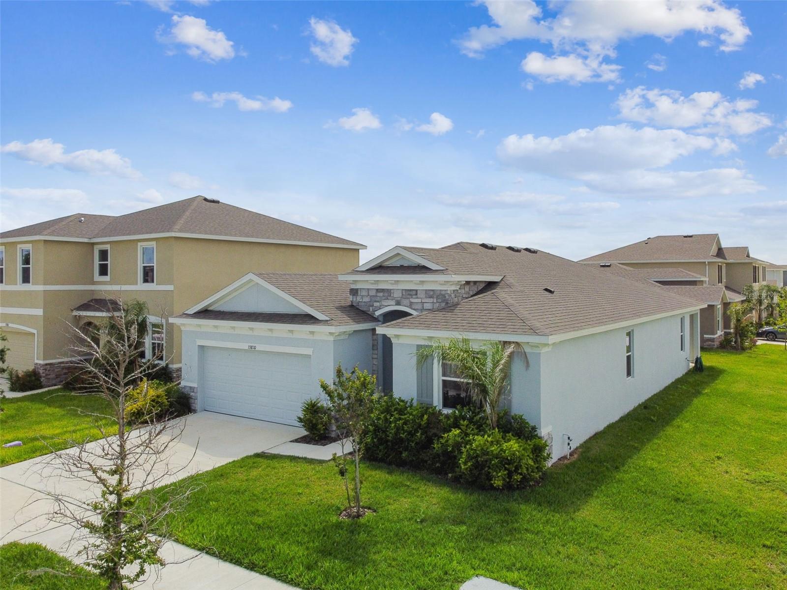 Welcome to this gorgeous brand new construction home in the heart of Wesley Chapel. Located in the vibrant and thriving neighborhood of Westgate at Avalon Park. This desirable area is buzzing with excitement, featuring a growing lineup of trendy shops, restaurants, and eateries that cater to all in the neighborhood TownCenter. This 4 Bedroom/ 2.5 Bathroom, sought after Lantana floorplan is perfection inside and out. You'll love the open-concept floor plan with abundant natural light making every room feel bright. This home boasts high ceilings and gorgeous large ceramic tile floors throughout. The open kitchen has beautiful solid wood cabinetry, granite countertops, a large island and all brand-new appliances. The master bedroom is spacious with large dual walk-in closets. The master bathroom includes dual vanities, a soaking tub and a walk-in shower. The 3 secondary bedrooms are adjoined by the 2.5 bathrooms in this split floor plan home. Ample storage all throughout with a 2-car garage. With its prime location, this home offers convenient access to top-rated schools, shopping, dining, and outdoor recreational activities. Don't miss this incredible opportunity to own a piece of paradise in Wesley Chapel. Welcome to your new home!