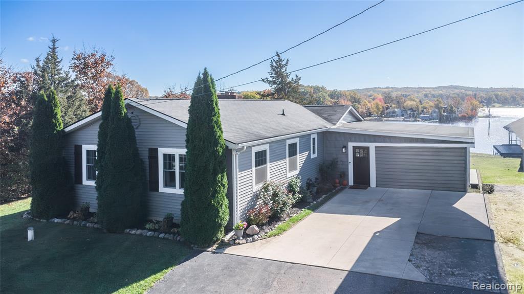 Lakefront Living on Private All-Sports Runyan Lake!  Make your dream of lakefront living a reality with this fully renovated 3-bedroom, 3-bath ranch offering 65 feet of sandy beachfront and breathtaking panoramic views. Perched high above the water, this home delivers the perfect blend of comfort, style, and year-round fun. Step inside to a spacious living room with a cozy gas fireplace and gleaming hardwood floors, seamlessly connecting to the sunlit dining area and updated kitchen—ideal for entertaining with lake views at every turn.  The walkout lower level features a wood-burning fireplace, large family area for movie or game nights, an office/craft space, laundry, and even a workout zone—plenty of room to live, work, and play!  Enjoy sunrise coffee on the 30x10 deck overlooking the lake, tend to your front garden, or unwind under the gazebo surrounded by beautiful landscaping. The bonus detached finished entertainment space adds incredible flexibility—perfect as a studio, guest hangout, or creative retreat—just steps from the water’s edge. All this comes with the unbeatable Runyan Lake lifestyle: fireworks, pig roasts, live music on the island, and a family-friendly community that makes every day feel like vacation. Stunning sunrises, sandy toes, and endless lake days await—schedule your showing today, because this one truly says “Home.”