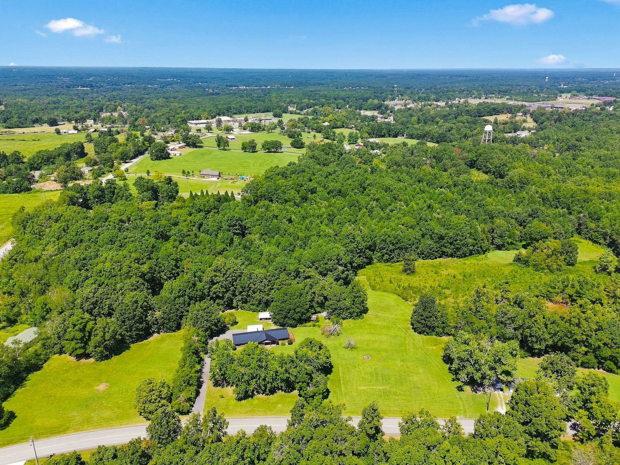 Rare opportunity on 36.7 acres just outside the Fairview city limits! Enjoy peaceful country living just 5minutes from shopping and restaurants and approximately 10 minutes from I-40. The property offers abeautiful mix of mature woods and open clearing, with plenty of possibilities to make it your own—create aprivate retreat, establish a farm, explore future development, or enjoy room for multiple generations.The home offers a unique and flexible layout with approximately 1,975 sq ft on the main side, featuring 3 bedrooms and 2 baths, plus an additional approximately 800 sq ft originally designed as in-law quarters.The separate living space could also work well for extended family, guests, a home office, or private apartment.  A special property offering acreage, privacy, convenience, and room to create your own vision. Buyer or Buyer's agent to verify all pertinent information.  All personal property will be removed from home prior to closing.