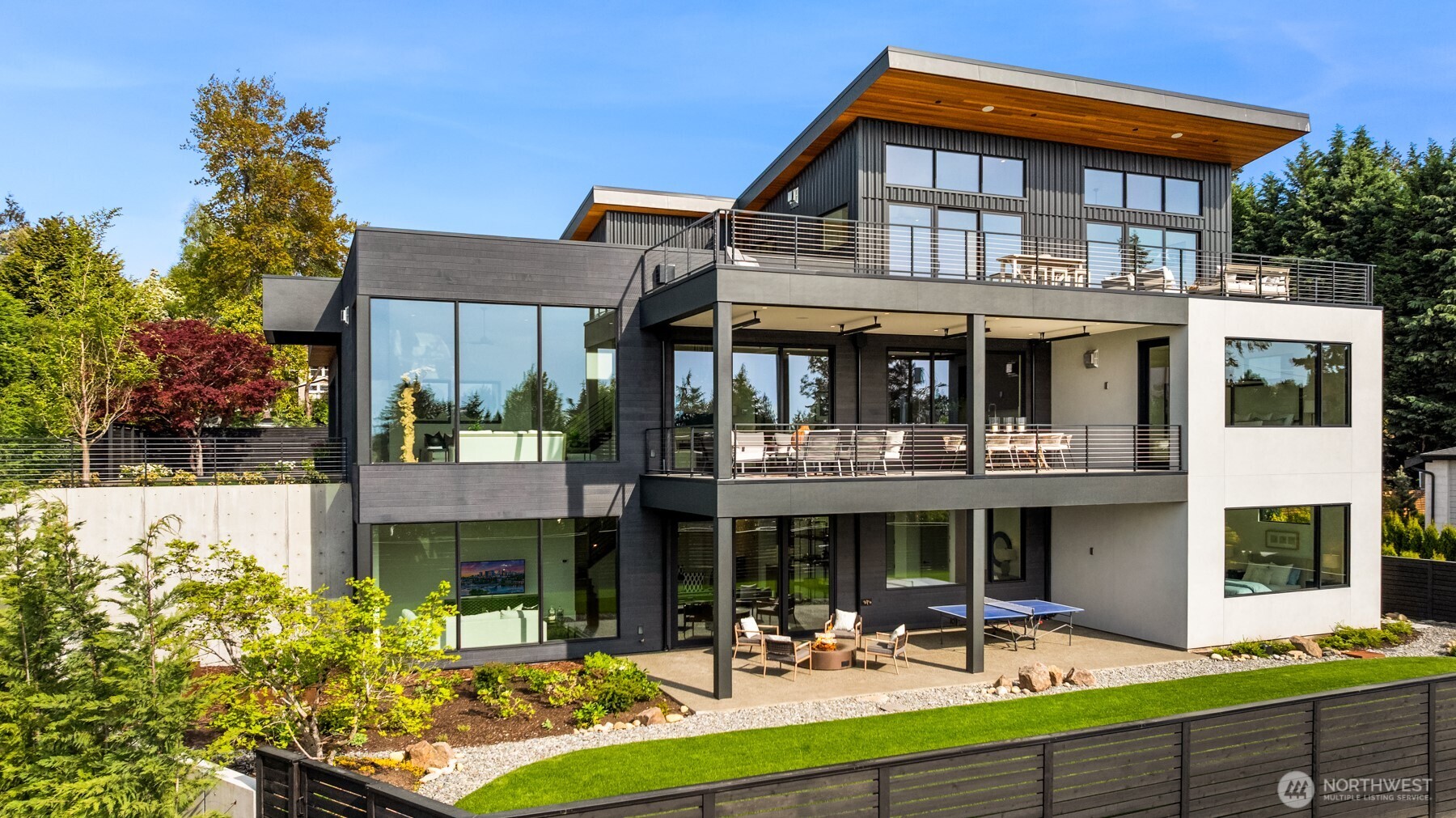 Attention to detail and craftsmanship are personified in this stunning new home built by respected local builder JBeloff Homes. Located down a private lane, this home is perched high to ensure privacy while giving you west facing, panoramic, horizon views making you feel like you are eye level with the Olympic Mountains. A beautiful combination of indoor and massive outdoor space allows you to squeeze every last moment of sunset year-round. Phenomenal bedroom layout with a spacious primary wing on the main floor with zero steps next to an elevator that services all floors. Upper floor has two gorgeous bedroom suites, one with west facing views and the other with downtown views surrounding a beautiful family room. Lower floor is wonderfully bright with high ceilings and an additional 3 large bedrooms, recreation room, secondary laundry, home theater, and flex room perfect for home gym, hobbies, and prewired for a golf simulator. Several options for den and home office. Natural light pours through near floor to ceiling windows that clears the mind and refreshes the soul. Sophisticated design elements hand chosen to be warm and welcoming. Secure private yard and gate ready for 360-degree security and peace of mind. Home has 3 car attached garage plus detached heated auto-salon perfect for a collector car, storage, or separate gym. Amazing location minutes to Overlake Golf & Country Club, Medina Elementary, St Thomas, 520, I-405, numerous parks, beaches, and downtown Bellevue