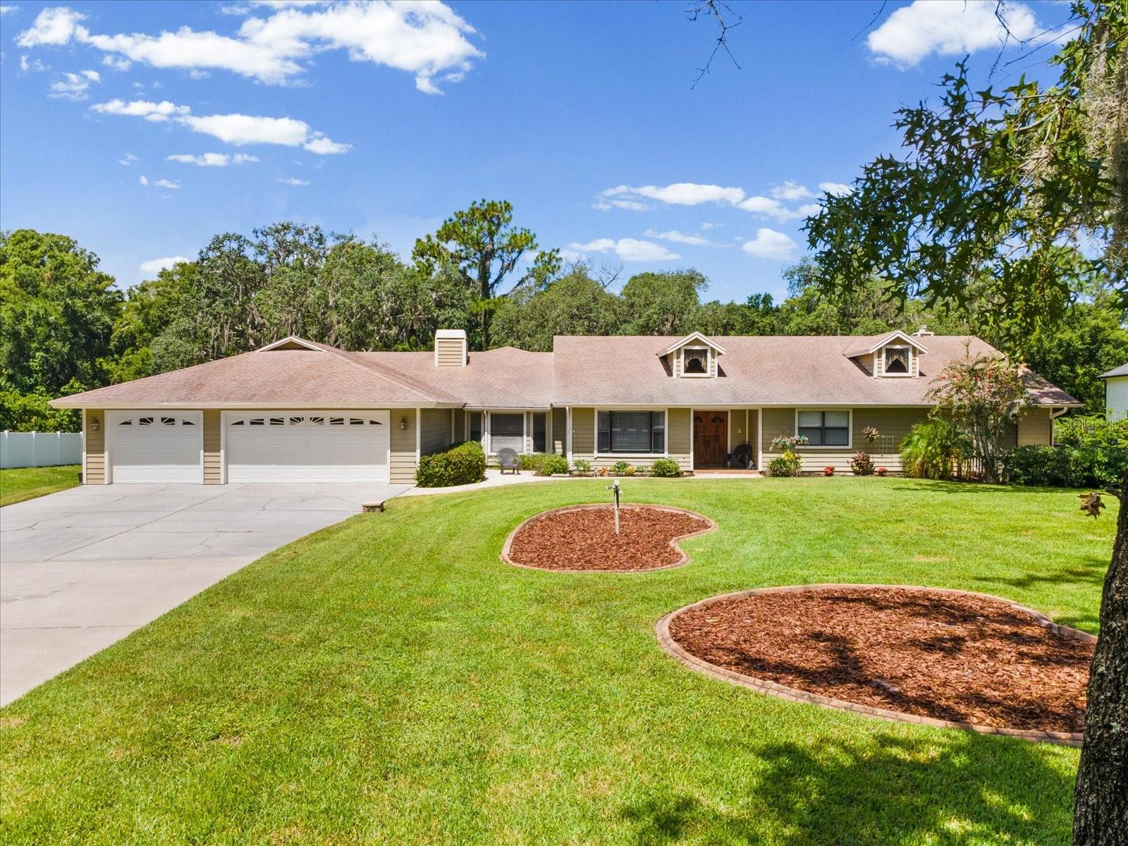 Welcome to 6655 Millstone Drive, a rare opportunity to own 1.53 acres in the highly desirable Oak Ridge community of New Port Richey. Set among mature landscaping, this estate-style property offers privacy and room to spread out with a fully fenced backyard, a PebbleTec saltwater pool and a versatile floor plan—all conveniently located near Trinity and the greater Tampa Bay area. As you enter through the double doors you’ll be welcomed into a spacious home filled with character, featuring luxury vinyl plank flooring, charming built-in details and a wood-burning fireplace. The kitchen was beautifully updated approximately five years ago, along with the all new appliances. The primary suite showcases an en-suite bath, walk-in closet and separate sitting room featuring its own wood-burning fireplace and a skylight window bringing in natural light. The backyard is a show stopper! With the PebbleTec saltwater pool, a fire pit area, mature landscaping and an expansive fenced backyard, the area creates an inviting setting for entertaining, recreation, pets or simply enjoying the outdoors. There is also a well house which includes the water softener system and a storage shed. The three-car garage provides plenty of space, along with additional converted garage space featuring a raised floor for a smooth transition into the adjoining living area which is currently being utilized as a  movie theater/game room with a projector screen, pool table, high end speakers and much more. Additional features include two A/C systems approximately five years old, a new pool pump about a year ago, and updated electrical outlets.  The location makes it easy to enjoy both the conveniences of Trinity and New Port Richey and the coastal lifestyle Tampa Bay is known for. Clearwater Beach, St. Pete beaches and the Gulf Coast are within minutes to an hour away. Trinity hospital is right around the corner and Tampa International airport is about a 40 min drive.  Book your showing today, to see this beautiful home in person!!