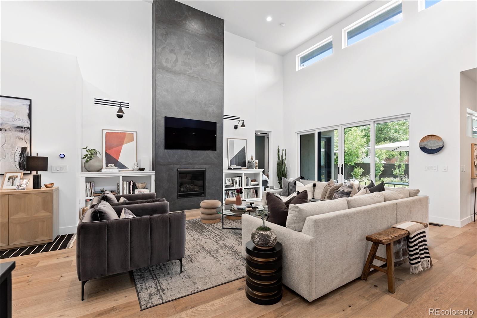 This stunning ranch home, built new in 2021, offers a harmonious blend of style and functionality. Upon entry into the foyer, you'll be wowed by the living space with 18' ceilings surrounded by transom windows bathing the space in natural light. The central gas fireplace wrapped in designer Porcelanosa Air Slate that extends from floor to ceiling, adds a touch of sophistication to the space. Open to the living room is a dining area and a gourmet kitchen anchored by a center island with waterfall quartz countertops. The showpiece of the kitchen is the Bertazzoni Italia gas range accented by a dimensional backsplash which extends throughout the room. A Bosch dishwasher, full size Electrolux refrigerator and freezer and in-ceiling speakers with wall controls complete the space. The spacious primary suite is a true retreat with an expansive walk-in closet and en-suite bath with a large dual sink vanity, freestanding soaking tub, glass shower and separate water closet. Also on the main level are two bedrooms separated by a generously sized bathroom, laundry room with built-in cabinets plus a powder bath with floor to ceiling designer tile. The basement is an entertainers delight with plenty of space for game tables and a seating area, is accentuated by 9’ ceilings and wired for data and a sound system. Adjacent you’ll find a gym with commercial rubber flooring and an in-wall water bottle filler. Completing the downstairs space are two bedrooms with walk-in closets, a spacious bathroom in between and large storage closet. Step outside to your beautifully landscaped backyard, a serene retreat featuring perennials, a rare paperbark maple tree and more. With a covered patio that has built-in speakers, it’s the perfect setting for relaxation and outdoor entertaining. Situated just a block and a half from Eisenhower Park, you'll enjoy a rec center with a pool and tennis/pickleball courts all within easy reach. Don’t miss the opportunity to call this exquisite home your own.