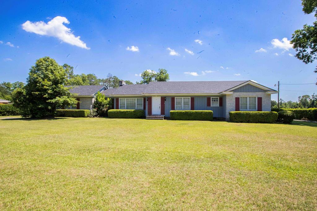 Hurricane ready! This property comes with a whole home generator ensuring worry free living with reliable back up power, especially helpful in storm season. If you are seeking the charm of small town living, this home is perfect for you. Situated on a picturesque street in the quaint downtown area of Doerun, this custom built home offers 4 bedrooms, 2 1/2 baths and awaits your personal touch to make it truly yours.   At nearly 2700 ft. , this spacious home features hardwood floors, custom-built cabinets and shelving and beautiful crown molding throughout. Other features include two woodburning fireplaces, smooth, tall ceilings, tons of closets and storage space. The master bedroom could be used as a mother-in-law suite as it has a sitting area, small kitchenette, and access door to the outside.  The house sits on .75 acres and is beautifully landscaped with a boxwood hedge all the way around the yard and has a workshop and shed.  Also features a covered two car garage, additional storage rooms, patio, and grill area and whole standby generator. Roof is less than a year old. Call today to schedule a viewing!