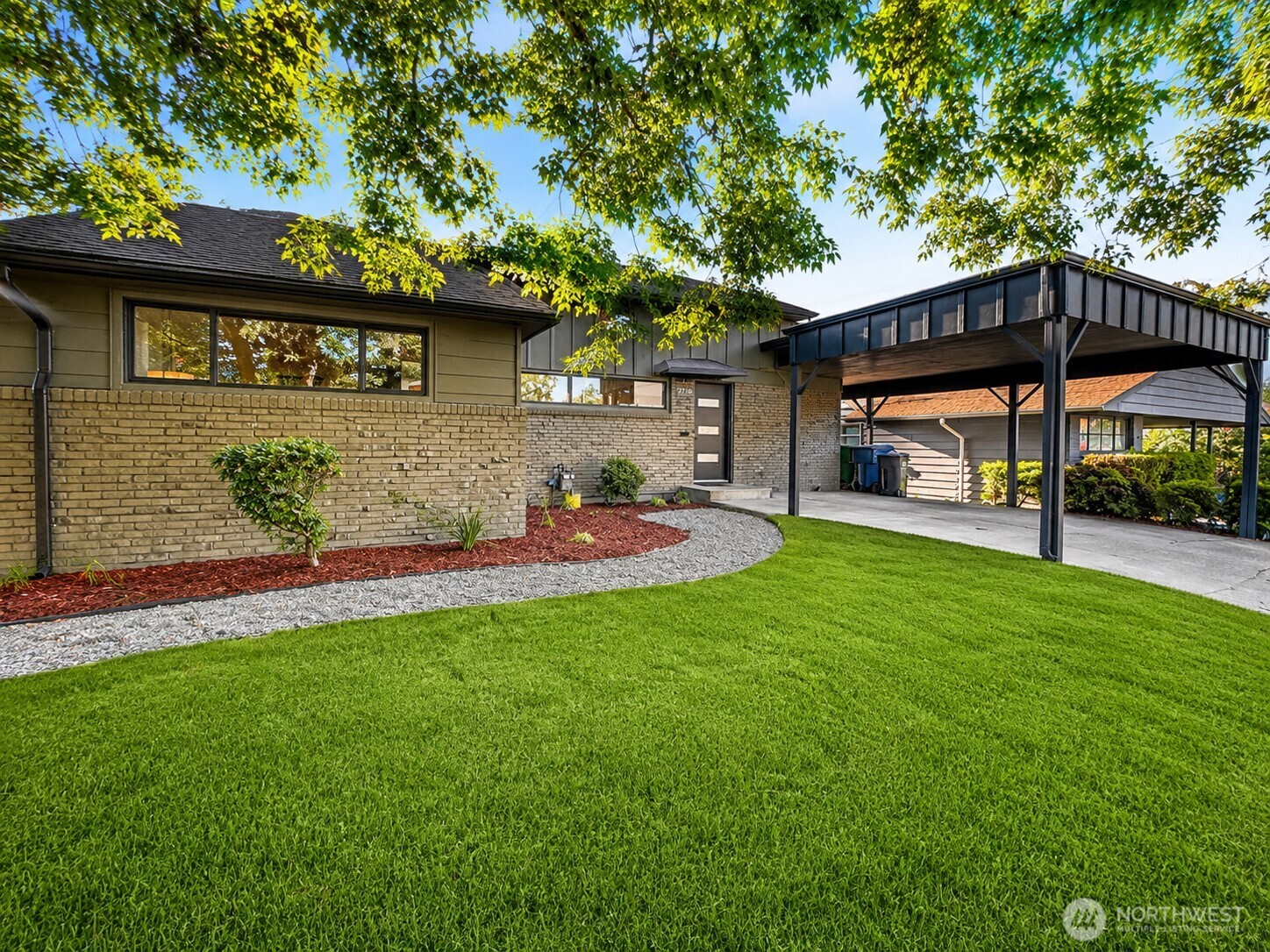 Beautifully remodeled 4-bed, 3-bath mid-century home with flexible lower-level suite, EV charger, fenced backyard, and bright open living spaces with vaulted ceilings and skylights. The main level offers 3 bedrooms, modern finishes, and an inviting kitchen/living/dining layout, while the lower level provides a private bedroom, full bath, spacious living area, and direct backyard access—ideal for guests, multigenerational living, office, or bonus living space. Enjoy outdoor entertaining from the deck, patio, balcony, and fully fenced yard. Convenient to parks, bike routes, public transportation, and Seward Park-area amenities. Move-in ready with space, flexibility, and modern updates.
