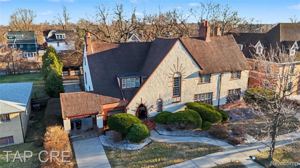 From the moment you enter the marble-floored foyer and ascend the grand staircase, you’re immersed in old-world elegance. The main level flows effortlessly from the formal living and dining rooms to a granite-appointed kitchen and charming breakfast nook. A sun-filled family room/library opens to a heated tiled sunporch, complete with a wet bar and hot tub—a one-of-a-kind retreat within the home. The flex room, accented by a fireplace, offers additional versatility as a study, office, or reading room.Upstairs, you’ll find five spacious bedrooms, including two primary suites, one featuring a private changing room and screened porch overlooking the rear garden. Four of the bedrooms have private or dual-entry baths, ensuring comfort and privacy for family and guests alike.The finished lower level continues the theme of entertainment with a Roaring ’20s-inspired bar room, recreation area, laundry, half bath, and ample storage. Above, a walk-up attic presents endless possibilities—ready to be transformed into an art studio, guest suite, or private apartment.Outside, the property impresses with a stucco facade inlaid with sandstone and brick, arched doors and windows, and a tiled, gated portico and carriage gate leading to a two-car garage plus a third bay with workspace and half bath. Even the doghouse echoes the thoughtful Tudor design.Rich in history yet fully suited for modern living, 244 Arden Park Blvd is more than a home—it’s an experience. Step into a lifestyle of elegance, heritage, and distinction, and own a truly iconic piece of Detroit history.
