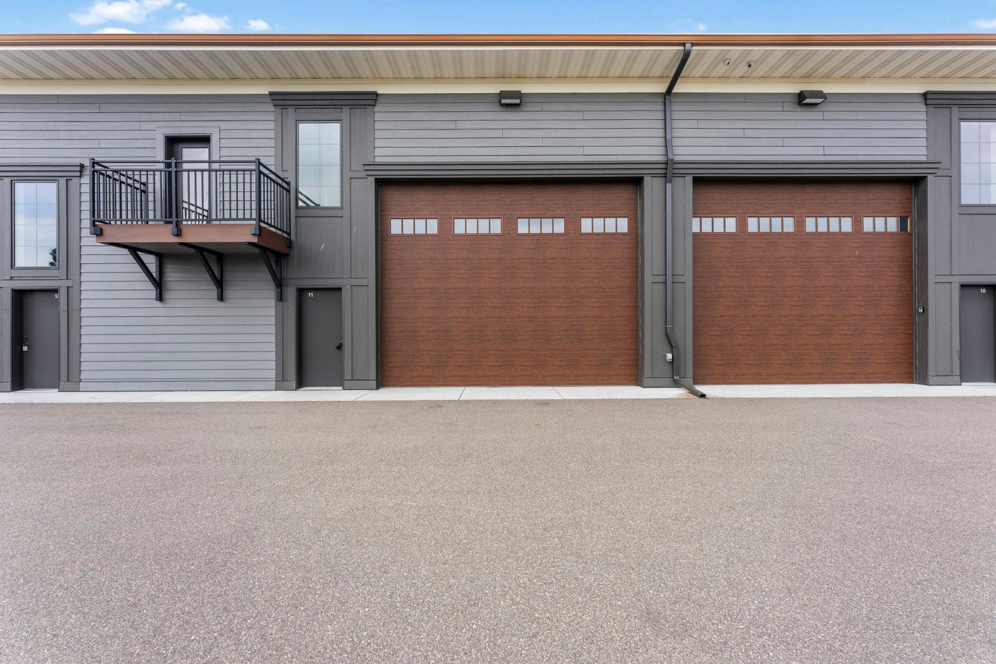Welcome to the ultimate blank canvas for the serious collector at the prestigious Medina Automotorplex. This unfinished garage condo offers the rare opportunity to create a space tailored entirely to your vision, whether you’re looking for secure vehicle storage, a professional-grade workshop, or a one-of-a-kind automotive retreat. Designed with functionality and future customization in mind, the main level features in-floor hydronic heating, a trench-style floor drain, fire suppression system, 150-amp electrical service, and an impressive 18'x14' remote-controlled garage door. An entry service door provides additional access, while the insulated and sheet-rocked interior is ready for your finishing touches. LED lighting includes two ceiling-mounted fixtures plus two additional LED lights beneath the loft, along with six quad 120V electrical outlets. The second level is roughed in for a rectangular loft and stairs, with an exterior ledger board and second-level full-light door already in place to support the future build-out. A plumbing stub-in adds even more flexibility for customizing the space to your needs. Outside, an exterior veranda adds a welcoming outdoor extension to the property and provides a comfortable spot to enjoy the surroundings. Located within the exclusive Medina Automotorplex, this is more than a place to store your vehicles—it’s an opportunity to build a private destination around your passion. Whether you envision a sophisticated collector garage, fully equipped workshop, or ultimate hobby space, the possibilities are yours to create.
