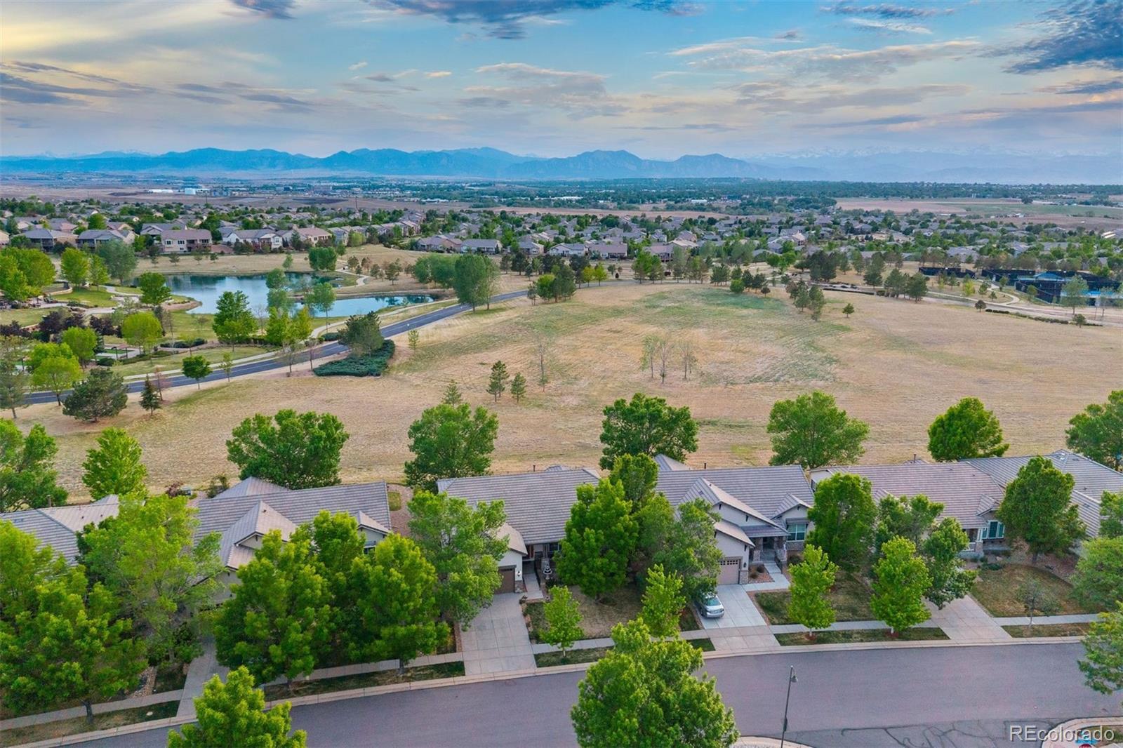 There's a particular kind of ease that comes with this stage of life, and if you've been searching for the next chapter, yours or someone you love, look no further! Anthem Ranch is an award-winning 55+ community where resort-style living meets some of Colorado's most breathtaking scenery. Main-level living, thoughtfully designed with well-proportioned rooms that feel connected to the landscape, backing to open space with Longs Peak and the entire Front Range filling the west-facing windows every single day. Archways soften the transitions between spaces, where oak hardwood floors anchor the kitchen and entry while plush carpet warms the great room, where a gas fireplace and soaring 10-foot ceilings invite you to settle in. The kitchen features rich wood cabinetry, white countertops, a butler's pantry, pull-out storage, and a pass-through that keeps the cook part of the conversation. An eat-in nook opens to the covered Trex deck, shaded, west-facing, and framed by the mountains. The main-level primary suite offers an 11-foot tray ceiling, a bay window framing Longs Peak, a walkout to the deck, and a bath with soaking tub, dual vanities, glass-door shower, and bidet. An office, second bedroom and bath, and generous laundry room round out the main-level. Downstairs, a spacious rec room, third bedroom, ¾ bath, and unfinished craft space complete the picture. Outside, a fully fenced yard, mature tree, and front-and-back irrigation complete a home that lives as beautifully as it looks. The 30,000-square-foot Aspen Lodge offers pools, hot tubs, a fitness facility, and a walking track, plus pickleball and tennis courts, over 120 clubs, and 48 miles of trails. Flatiron Crossing is just 15 minutes away for dining, shopping, and entertainment.