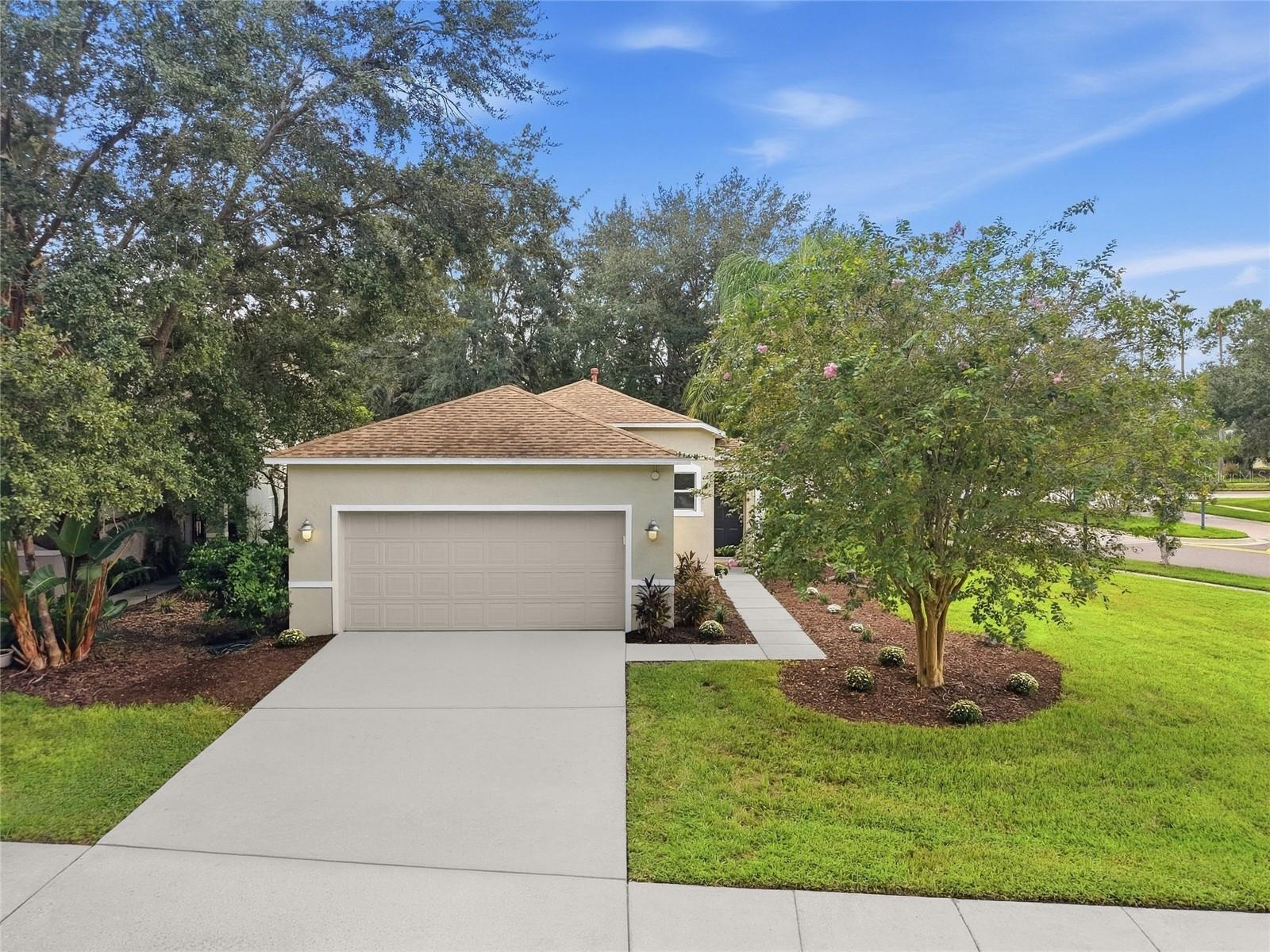 Welcome home to 2306 Spring Hollow Loop in Wesley Chapel, FL! Situated on a spacious corner lot directly across from a peaceful community park and walking trails, this rare 3-bedroom, 2-bathroom, 2-car garage gem offers low-maintenance Florida living at its finest. From the moment you step inside, you'll love the bright, functional layout and timeless finishes throughout this clean, move-in ready home in the sought-after Seven Oaks neighborhood.Warm wood flooring flows through the main living and dining areas, leading directly into a chef’s kitchen equipped with crisp white shaker cabinetry, durable Corian countertops, a stylish tile backsplash, a generous pantry, and stainless steel appliances featuring a gas range.Designed with privacy in mind, the split-bedroom floor plan positions the primary suite at the rear of the home—the perfect retreat at the end of a long day, complete with a spacious walk-in closet and a soothing garden tub/shower en-suite.Unbeatable community & location! Beyond the front door, enjoy Seven Oaks’ premier resort-style amenities, including a grand clubhouse, pool with a waterslide, splash park, fitness center, movie theater, tennis and volleyball courts, and scenic nature trails.Positioned in the heart of Wesley Chapel’s booming growth, you are just 5 to 10 minutes from The Shops at Wiregrass, Tampa Premium Outlets, and The Grove. You are also moments away from top-tier medical facilities, quick I-75 access, AdventHealth Center Ice, and the upcoming downtown district featuring Whole Foods, Publix, and a flagship Target.Clean, well-maintained, and perfectly positioned with front-row park views—schedule your private tour today!