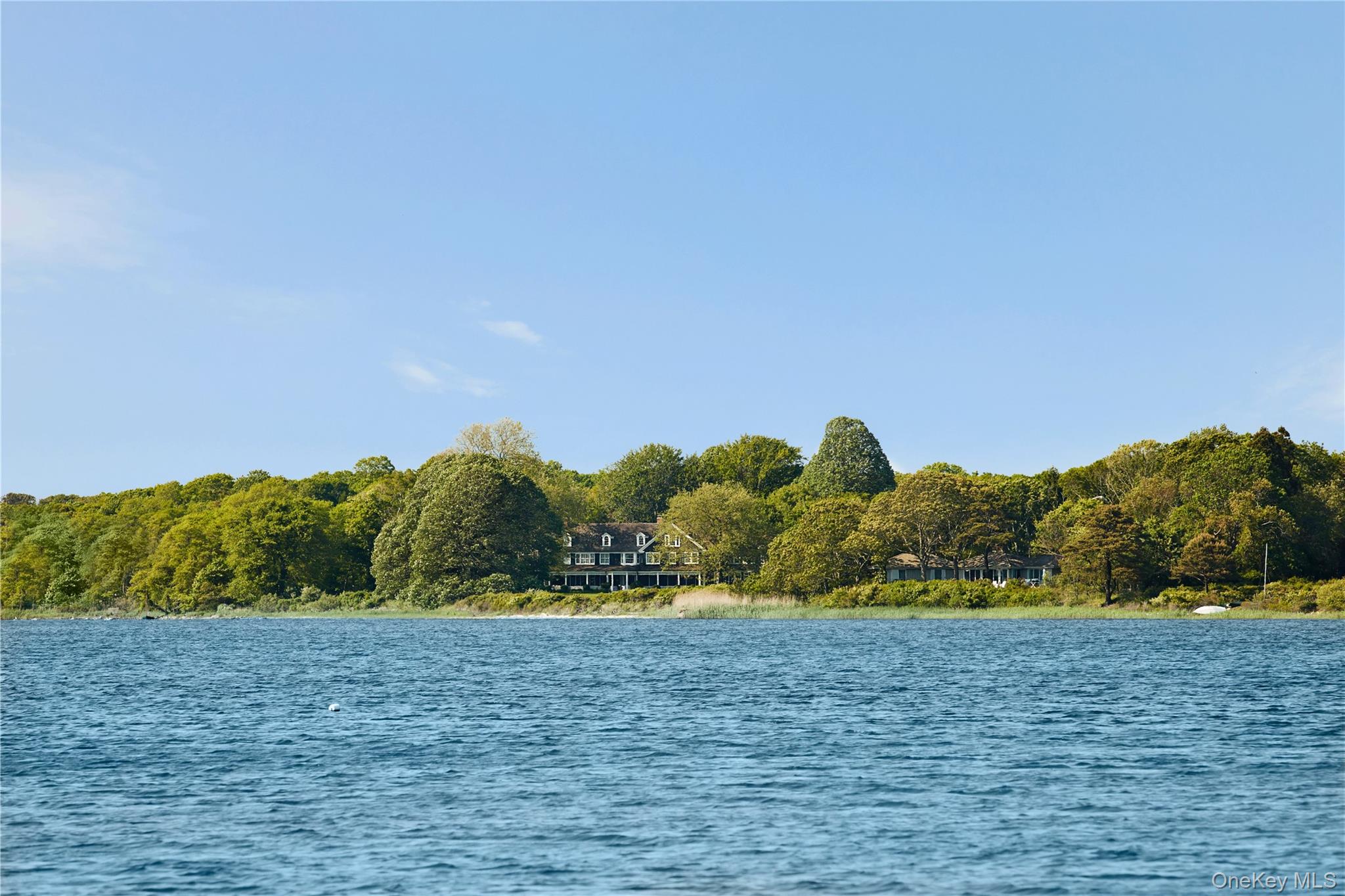 Commanding nearly a quarter-mile of pristine frontage on Georgica Pond, 100 & 90 Briar Patch is one of East Hampton’s most extraordinary waterfront estates. Encompassing two contiguous parcels across 11.2+/- acres, this rare compound offers an unparalleled level of privacy, scale, and natural beauty, complemented by approximately 13,800+/- square feet of exquisitely curated living space.Positioned to capture sweeping southwestern views, the estate enjoys breathtaking sunsets over Georgica Pond, with the Atlantic Ocean shimmering on the horizon beyond. A property of exceptional pedigree and provenance, Briar Patch presents a once-in-a-generation opportunity to own a landmark East Hampton retreat where history, architecture, and setting converge in perfect harmony.The main residence, originally constructed in 1931, is a masterful expression of timeless elegance and architectural distinction. Designed for grand-scale entertaining and sophisticated living, the home encompasses six bedrooms, eight full baths, and two powder rooms, along with an array of expansive gathering spaces. Rich in character and craftsmanship, the interiors seamlessly blend old-world charm with refined contemporary comforts. French doors throughout the residence open to expansive terraces and outdoor entertaining areas, creating a seamless connection to the estate’s spectacular waterfront surroundings.Set on a separate 3.7+/- acre parcel, the guest house was designed by renowned architect Peter Marino and completed in 1990. Both modern and enduring in its design, this exceptional residence offers four ensuite bedrooms, four full baths, and a powder room. Coffered ceilings, a fireplace, and beautifully proportioned living spaces create an atmosphere of understated luxury, while a full kitchen and private accommodations provide the ultimate retreat for family and guests.Between the two residences, a heated gunite pool and spa serve as the centerpiece of the compound’s resort-like amenities. Meandering nature trails wind through mature specimen trees and lush natural landscaping, leading to a secluded private pond. From the property’s shoreline, residents can sail, paddleboard, or kayak across Georgica Pond directly to the ocean, embracing the quintessential East Hampton waterfront lifestyle.Originally commissioned by Arthur C. Jackson, the main residence was designed by the celebrated architect behind the plans for the New York Public Library and Lasata, the childhood home of Jacqueline Kennedy Onassis. In 1990, Peter Marino further elevated the estate, thoughtfully enhancing the main residence while introducing the guest house, creating a cohesive architectural vision across the compound.Ideally situated south of the highway on coveted Briar Patch Road, the estate is moments from East Hampton’s celebrated ocean beaches, fine dining, and luxury boutiques, accessible by car or boat. Rarely does a property of such magnitude, heritage, and seclusion become available. 100 & 90 Briar Patch stands as one of the Hamptons’ most distinguished private estates - a legacy property of enduring significance.