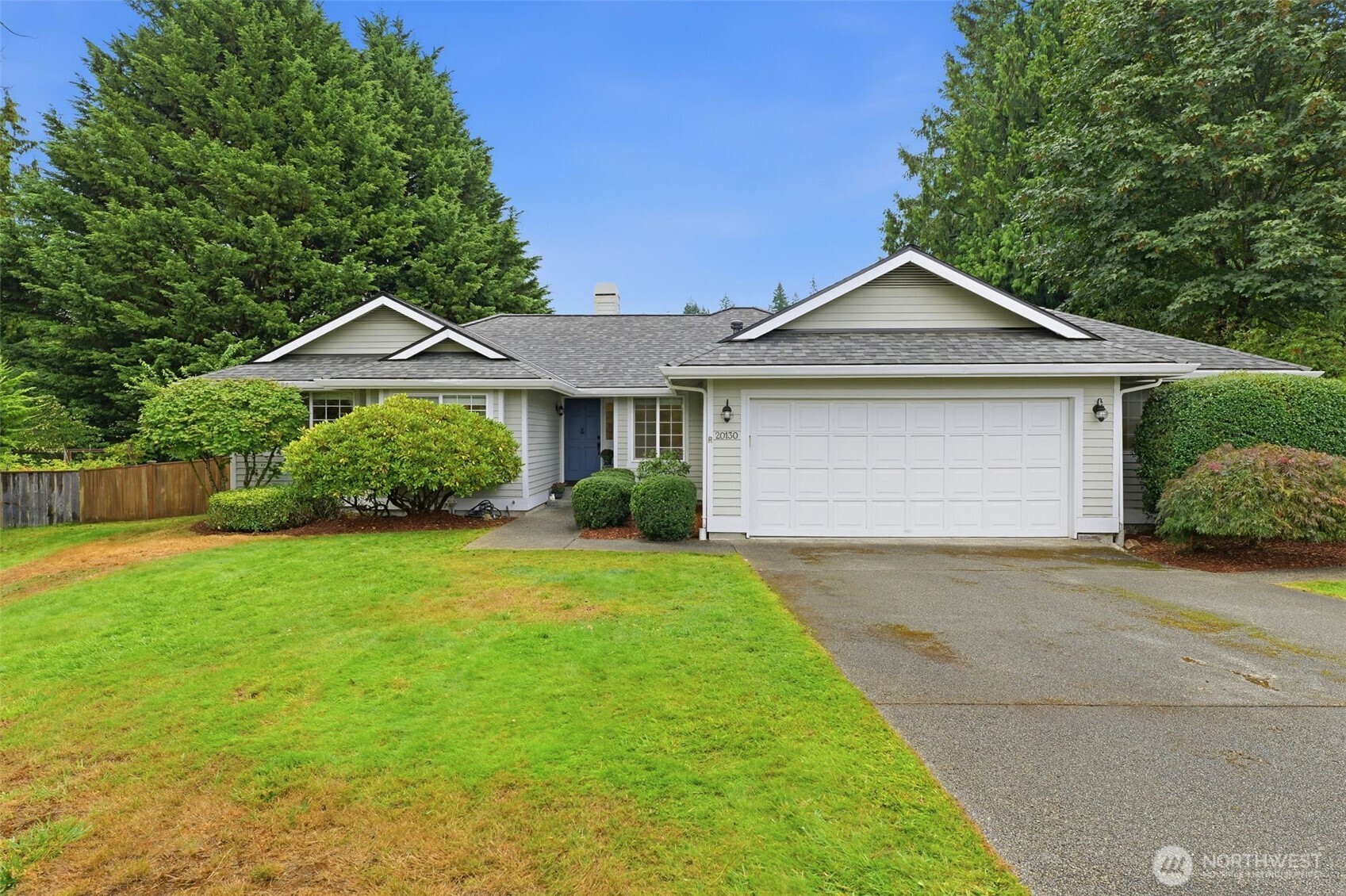 Welcome home to Forest Rock Hills! This immaculately maintained single-story home built by Terhune Homes offers the ideal blend of comfort, quality, and everyday convenience. Nestled in one of Poulsbo’s most sought-after neighborhoods, this 3-bedroom, 2-bath floor plan features glowing hardwood floors and high vaulted ceilings that create a bright, airy feel throughout the main living areas. The open kitchen flows seamlessly into the main living space—complete with a cozy gas-log fireplace—making entertaining an absolute breeze. Home features updated countertops in both the kitchen and bathrooms, along with a double oven and a stylish farmhouse sink. Primary suite includes an en-suite bath with a skylight for soothing natural light and a walk-in closet. Step outside to your fully fenced, private backyard retreat with a spacious patio and garden area, perfect for summer gatherings and outdoor dining. Attached two-car garage features built-in workbench space, and peace of mind comes easy with a roof replaced within the last 5 years. Unbeatable location: walk to Town and Country, local schools, and historic downtown Poulsbo with easy access to Hwy 3 and an easy commute to the Bainbridge Island Ferry. Move-in ready!