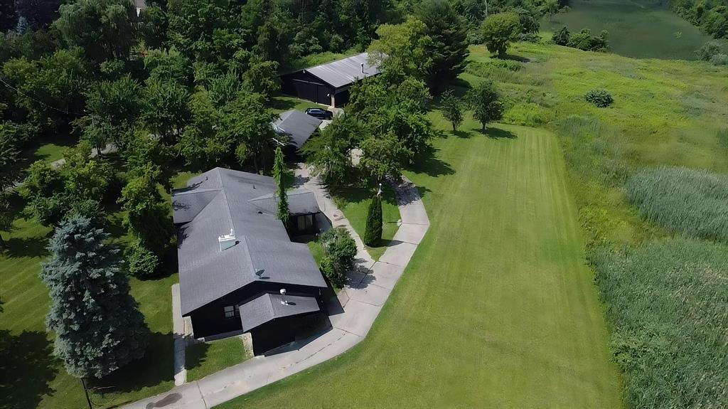 An exceptional opportunity to own 80 +/- acres with over half a mile of frontage on the Black River.The land is rich with wildlife, offering outstanding hunting opportunities alongside true year-round recreational appeal. Enjoy boating, swimming, fishing, trail riding, and hayrides throughout the warmer months, with plenty of space for family gatherings and outdoor activities. In the winter, the property transforms into a private playground featuring a natural sledding hill and a pond ideal for ice skating.The existing home offers generous living space and has recently been updated with new paint, carpet, and vinyl plank flooring. A detached three-car garage and a large 42x80 barn, complete with water, electric, and its own bathroom, provide excellent utility for vehicles, ATVs, livestock, or hobby use. A private boat launch offers direct access to the river.Beyond recreation, the property presents potential for income generation through farming, hunting leases, or possible event/venue rental opportunities. All structures have received new roofs within the past seven years, helping minimize future maintenance needs.City water, sewer, power, and natural gas appear to be available at Beach Road, offering additional potential for future development or expansion. Buyers should verify availability and connection requirements with Port Huron Township.