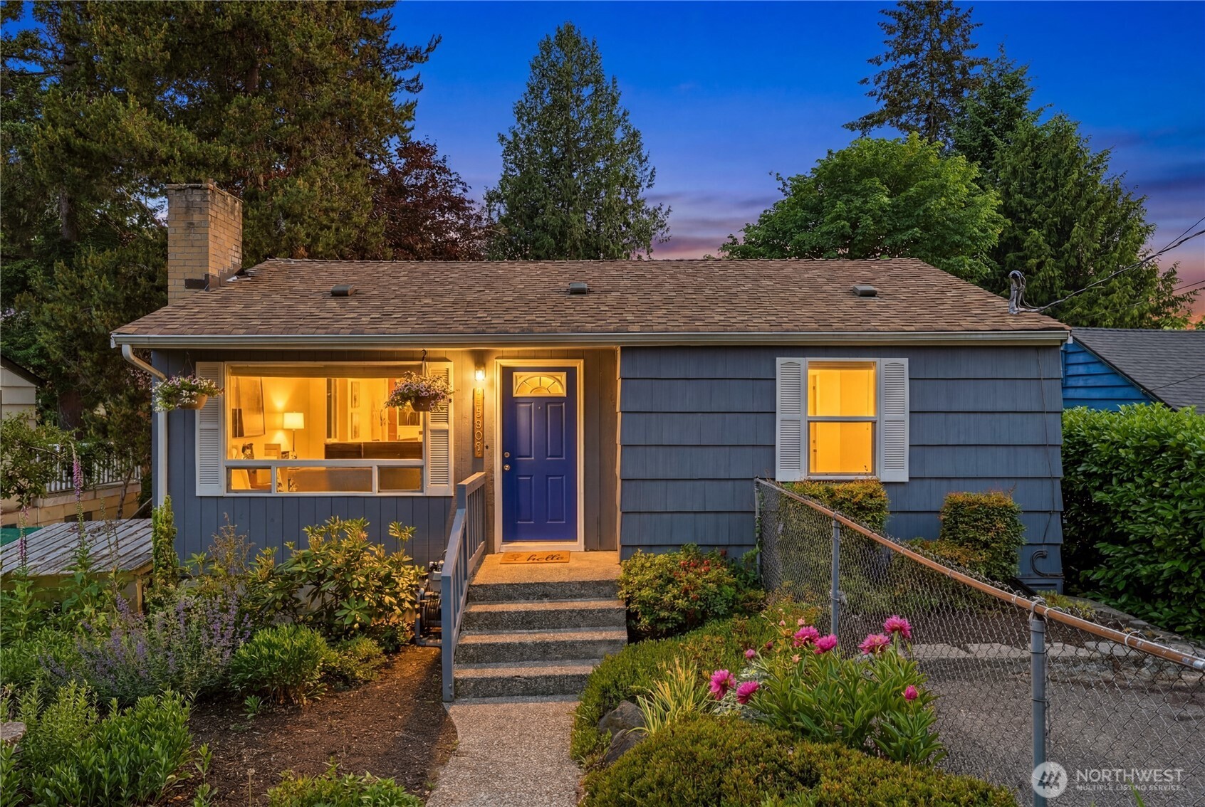 Genuine peace and quiet in the heart of the city may seem unlikely, but this thoughtfully updated Shoreline home delivers exactly that. At just over 1,600 square feet, it delivers urban walkability without sacrificing the calm, green surroundings you'd expect to find well outside city limits.  The spacious living room greets you with a classic bay window framing mature ornamental gardens outside. Come winter, gather by the fire; come summer, stay comfortable with central heating and AC powered by a newer heat pump. Down the hall, you'll find a recently updated full bath and well-proportioned bedrooms.  The open kitchen flows naturally out to a massive west-facing deck, freshly treated and ready for weekend barbecues. Beyond it, a fully gated backyard offers something truly special: established flower beds, a working herb garden, a greenhouse, and plenty of room for an urban farm or simply an afternoon in the sun.  A separate entrance leads to a freshly updated flex space, ideal as a playroom, home gym, or office, followed by a generous third bedroom and utility room with a brand new LG washer and dryer. Plumbing access here presents an exciting potential opportunity for a future second bathroom (buyer to verify).  And when you're ready to venture out? A movie theater, restaurants, bars, cafes, markets, parks, and all three neighborhood schools are all within walking distance, with quick transit access just moments away.