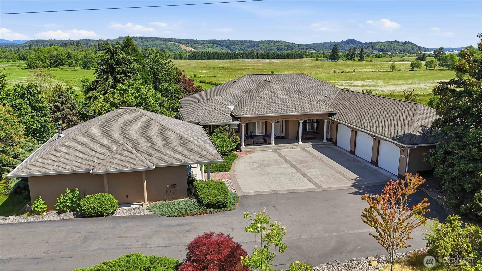 A rare, gated estate for the buyer who wants it all. Car enthusiasts, take note: the 48x48x70 climate-controlled shop features 300-amp service, 220 plugs, compressor air, fast EV charging, epoxy floors, a full bathroom, security system, and a dedicated paint booth. A second 36x24 climate-controlled shop currently serves as the ultimate home gym. The 3,139 sq ft main home offers 4 bedrooms plus a den, 2.5 baths, hardwood floors throughout common areas, a gas fireplace, central vac, and a chef's kitchen with large island, gas cooktop, double oven, and granite countertops.  Master bath is a 5-piece bath with a soaker tub.  Step outside to a wrap-around Trex deck and heated pool. A detached 840 sq ft ADU with 2 beds and 1 bath adds flexibility for guests or rental income. Irrigated landscaping draws from a private well, a zip line, kids play structure, and a private pond. All of this on just under 5 peaceful acres — minutes from amenities.  Please inquire for more photos.