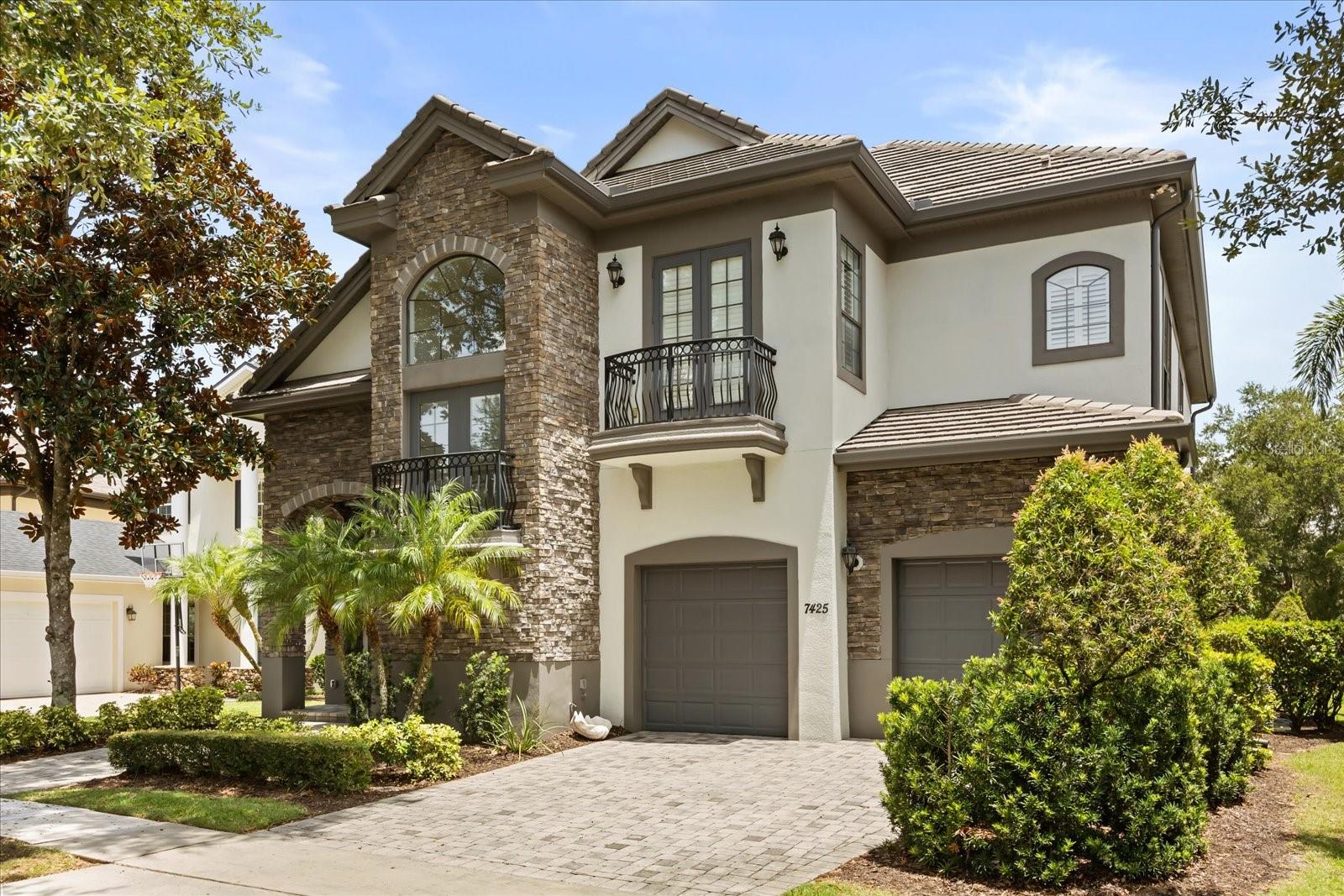 Under contract-accepting backup offers. ** EASY TO SHOW** Luxury, Lifestyle and Legacy is on full display at this beautiful home located in the Homestead Community at Reunion Resort.   Welcome to 7425 Gathering Court. This four bedroom, four and ½ bath home is located on a quiet tree lined street that gives you the best of Florida living.  A golf course view home that gives you a great seat for hole number 4 on the Watson Golf Course.  The noticeably well-maintained landscaped yard surrounds the home and has this property standing out with an extremely high level of curb appeal that is accented by the custom stone work.  IT IS NOT IN A RENTAL PROGRAM.  Once you enter the home you are greeted by a formal sitting room and dining room that has been accented by upgraded modern lighting choices.  You can’t help but notice the height of the ceilings, and the wonderful craftsmanship that has gone into the staircase railing that outlines the second floor. The first-floor master is a must and is an oasis that is the quiet get away that you have been searching for.  The space includes new flooring, newer paint, and a generous master closet that has been outfitted with organizational shelving.  You won’t have to lift a finger!  The well-appointed kitchen includes a new cooktop with higher end appliance selections that also includes a new refrigerator.  Please also note that the cabinetry chosen for this home is by European Designer Poggan Pohl. The first floor living space is accented by 22ft tall ceilings, elevated windows, recessed lighting, and 2 walls of sliders that let in tons of natural day light.   There is also breakfast bar seating along with a separate sit-down dining space.  The back of this home is just as special as the front.   You will love to look out over the pool and pavers that showcase the entertaining spaces. Especially with no rear neighbor! It is also worth noting that the outside spaces do provide shade and covered portions.  There is an outdoor living room that is outfitted with a large television and fireplace, which is the best place to watch a movie or a game by the pool!  In the upstairs of the home, you will find the additional bedrooms, loft area and theater room, along with BRAND NEW flooring.  Each bathroom has been re-imagined and updated which adds to the charm of the home.  The owners made sure to give this home the care and attention to detail that it deserved.  The property also includes a Theater Room with upgraded seating along with a BRAND NEW PROJECTOR.   Who wants popcorn?  So many upgrades to list that include a Rinnai tankless water heater, a new Aqua link pool heater with remote access, lighting, appliances, etc.  Please see attached list.   Reunion Resort has everything you want in a community including 3 signature golf courses, world class dining, waterparks, lazy river, water slides, firework viewing areas, tree lined streets, dog park, playground, driving range, golf simulator, member events, in-resort shuttle service, and event space. Live the resort lifestyle like a VIP. NO OTHER RESORT IN THE AREA HAS THIS!!! Easy to show and even easier to Enjoy! Reunion Resort Membership available.