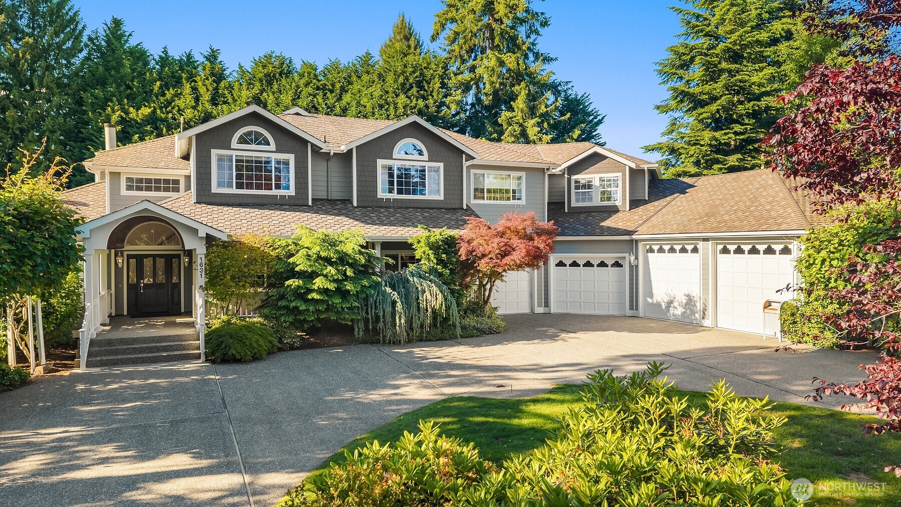 Rare opportunity to own a private 1.2+ acre estate in Lynnwood's Larch Way. Surrounded by mature landscaping, this property offers true privacy and convenience just minutes from I-5, I-405, Alderwood Mall, dining, & Light Rail. Designed for comfortable everyday living and effortless entertaining, the 4-bedroom home with bonus room and den features soaring ceilings, abundant natural light, rich millwork, formal and informal living spaces, and a main-level office. The gourmet kitchen features Sub-Zero refrigerator, granite countertops, extensive custom cabinetry, a gas cooktop island, and a skylit dining area that flows seamlessly to the outdoor living spaces. Double doors lead to the Primary Wing featuring vaulted ceilings, own gas fireplace, and a generous full ensuite bath with dual vanities, a makeup station, walk-in shower, and soaking tub. Flexible living areas throughout the home offer endless possibilities for multigenerational living, guests, or evolving lifestyle needs. Outdoor amenities: covered deck, multiple gathering spaces, patio, greenhouse, hot tub, above-ground pool, play area, raised garden beds, fruit trees, berries, expansive lawns, and mature evergreen offering privacy screening. A circular driveway and abundant guest parking complement the impressive 4-car garage, featuring two oversized bays ideal for RVs, boats, workshop space, or additional storage.