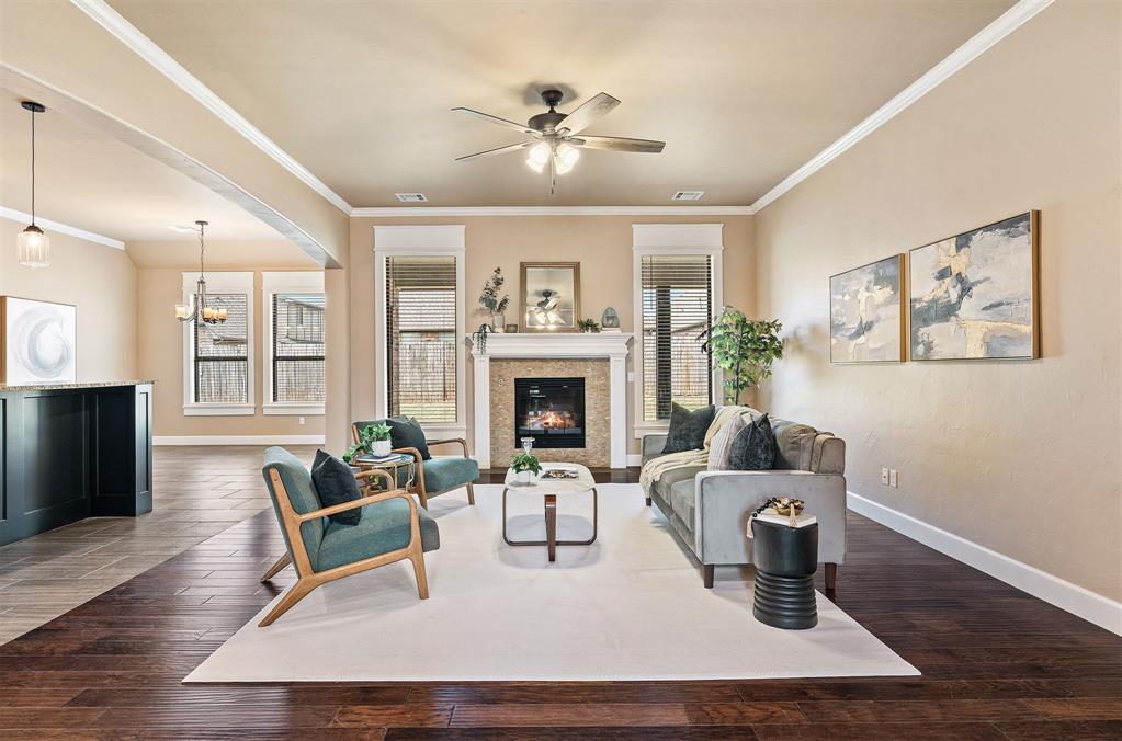 This immaculate 2,800+ sq ft home offers you everything you could want. The open concept first floor presents you with a dedicated formal dining space, a gas fireplace, high end cabinetry and custom vent hood over the brand new gas range, new dishwasher and ovens, large island, walk-in pantry, and high-end fixtures, not to mention the hardwoods throughout & tons of natural light! The downstairs primary is spacious with tall ceilings, as well as a massive ensuite with a walk-in shower and jetted soaker tub. The remaining bedrooms are all generously sized with large closets. The mud room & laundry space has ample cabinetry, countertop space, and has plumbing ready for a sink to be installed! Upstairs you have a large space that could be used as  a 4th bedroom, office, media room, or flex/bonus space. The upstairs area also has an attached full bathroom and closet. The oversized 3-car garage has a built-in storm shelter. The backyard has a large covered patio area and has a gas line ready to hook up your grill! This home is what you've been waiting for...schedule your private showing before it's too late!