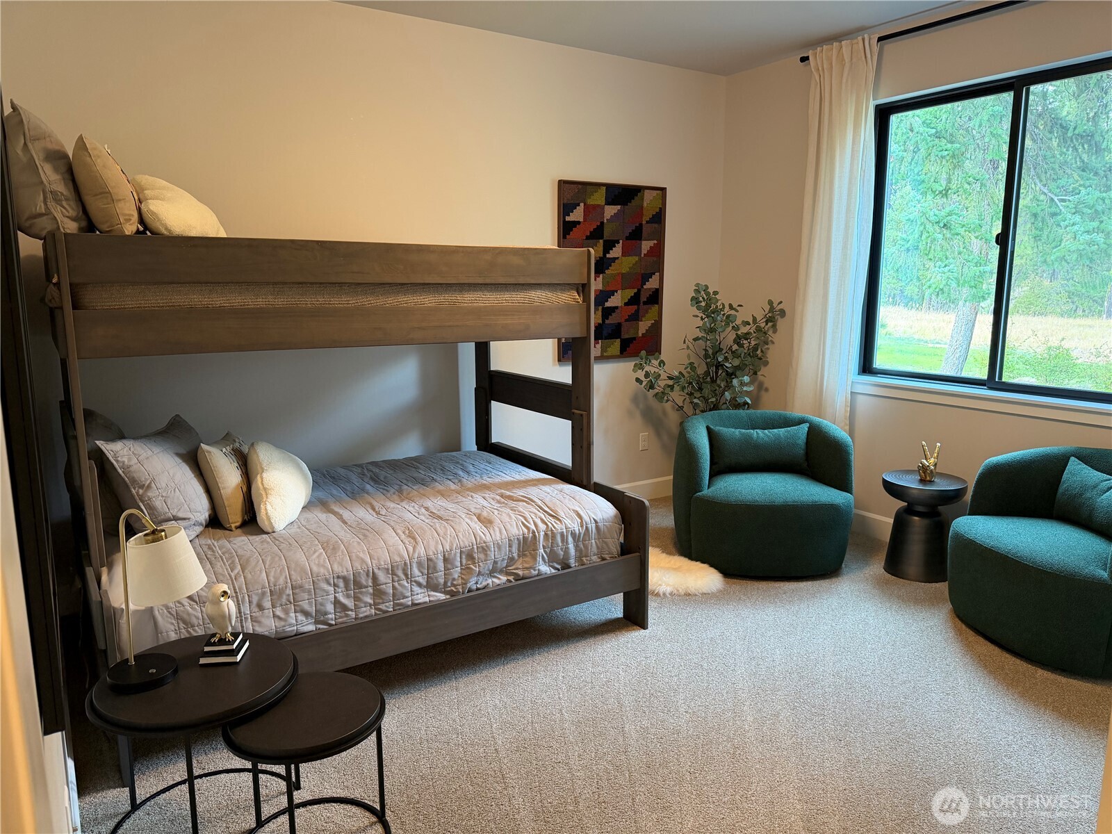 The third bedroom offers wonderful flexibility as a guest suite or fun bunk room, complete with an incredible view overlooking the peaceful natural conservancy.