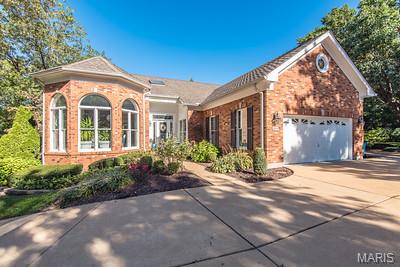 SHOW STOPPER! Welcome to 604 Spyglass Summit Drive an exclusive beautiful gated community. This stunning villa has over $290,000 in fully renovated kitchen, bathrooms, freshly painted walls in every room,  brand new porcelain  tile floors, life proof basement floors.  New carpet on the open staircase and wrought iron spinals with  espresso black  hand rails! This home is a MUST SEE! This All-Brick Villa with over 4300 finished sq feet has been loved and well maintained and ready for the next home owner to experience luxury at its finest. The gorgeous gourmet chefs dream kitchen was fully renovated 2025! Custom made cabinetry with a 10 ft. center island with built ins and loads of storage. Leathered granite counter tops thru out and high end GE Cafe appliances. As you walk thru the main level you will notice the stunning new tile floors along side the hardwood floors that flow into the dining room, family room, and both upstairs bedrooms. Main floor laundry with utility sink and closet  with access to 2 car fully drywalled garage with epoxy flooring.  All 3 bedrooms have on-suite bathrooms.  Bonus 4th bedroom lower level.  The Lower Level has new LVP floors and fresh paint with a fully renovated bathroom with Amish made cabinetry. Both HVAC systems were replaced in 2022.  The massive main floor living room offers a fireplace flanked by built in bookshelves, a sliding glass door leading to a quaint composite deck.  Vaulted Primary suite with custom built in's walk in closet, bay window & one of the largest bathrooms you will see! Lower level offers over 2000 sqft of living area featuring Family room with 2nd fireplace, 2 bedrooms, full bathroom & wet bar.  Huge utility / storage room w/ cedar closet. Bonus glassed in sun room off of the walk out slider.  This community just had $100,000 in renovations to the pool house and pool area directly across from the Villa!