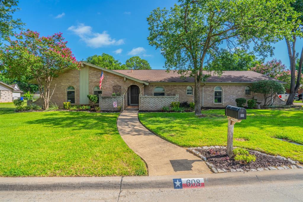 Don't miss this spacious, meticulously cared-for Colleyville home offering a rare five-bedroom floor plan with three full baths, and room for everyone to spread out. Nestled beneath mature shade trees on a quiet street, this home features a generous living area, two dining spaces, and an oversized covered patio overlooking a beautifully sized backyard—perfect for entertaining, backyard games, or simply enjoying Texas evenings. One of the home's standout features is the second primary suite, complete with a private ensuite bath and separate exterior entrance which provides exceptional flexibility for extended guests, a private home office, a hobby space or simply a quiet retreat. This home has a floorplan that is designed to adapt as your needs change. The detached two-car garage provides ample parking and storage while preserving the home's versatile floor plan. The bright kitchen features abundant cabinetry, double ovens, stainless steel appliances, and opens to the adjoining living and dining areas. Throughout the home you'll find spacious secondary bedrooms, one of which features hand-painted storybook murals that can be enjoyed as-is or easily transformed to suit your own style. Throughout the home you'll find durable flooring, generous storage—including an exceptionally organized laundry room—and a layout designed for comfortable everyday living. The charming courtyard entry and distinctive arched windows add timeless curb appeal. Conveniently located near shopping, dining, Colleyville City Park, and award-winning Grapevine-Colleyville ISD schools, this lovingly maintained home is ready to welcome its next owners.
