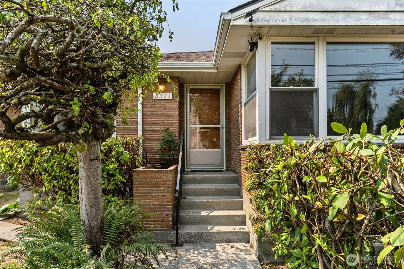 A REAL CLASSIC! Nestled in the Ballard / Greenwood district there's a Brick House of nearly 2000sqft with living and dining rooms, an inviting kitchen with a breakfast nook, 2 bedrooms and a full bath upstairs and a separate living area downstairs, which includes a living/family room, a full kitchen, a could-be bedroom and a 3/4 bathroom. This home shouts RETRO! Though it's got some age to it, you won't believe just how good the condition of this home, especially the woodwork, actually is. It's now ready for you to take ownership and add your very own personal classic touches.   As far as the location, let's be clear, the Ballard / Greenwood has a personality all of it's own. With high walk and bike scores, activities that can easily be reached include restaurants, coffee shops, boutiques, breweries and entertainment, all intermingled with well established residential neighborhoods. Outdoor amenities include Golden Gardens Park which provides a sandy Puget Sound beach, trails , picnic areas, volleyball, fire pits and impressive sunset views. Nearby is the fascinating Ballard Locks that offers salmon viewing, beautiful grounds, including the Botanical Garden. You get ability to have an active urban lifestyle without feeling as though you live downtown. Plus, Greenwood Park is a neighborhood gathering place with open lawn, playground facilities, picnic areas and games. Definitely an easy reach to Green Lake, Woodland Park and of course, the Zoo.. Location - Location - Location!