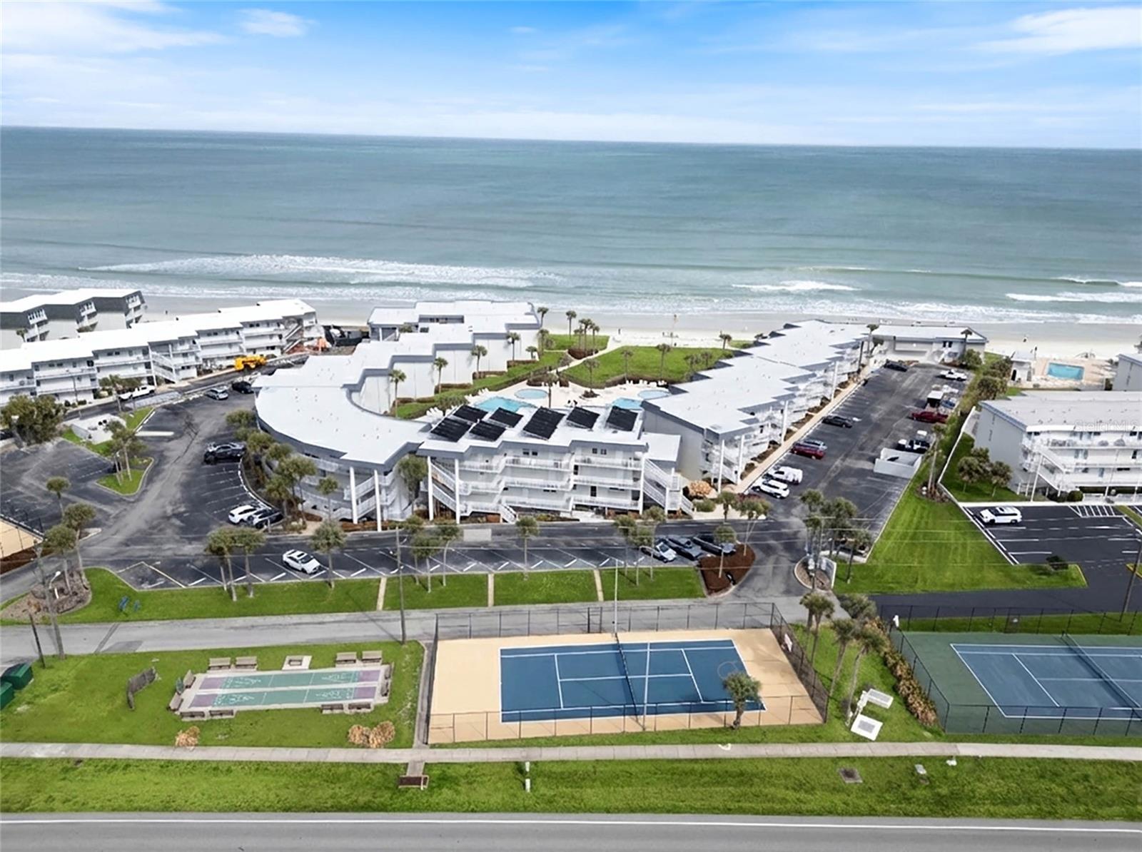 HOW CLOSE CAN YOU BEACH!?!? Beautifully Renovated, Direct Ocean-Front, Two Bedroom, 2.5 Bathroom Beach Pad on NSB's coveted No-Drive Beach. A unique opportunity. You'll never want to leave this beautifully renovated beach pad with FULL OCEAN and BEACH VIEWS. This residence is located on the 2nd and 3rd floors of the "F" Bldg., and is perched next to the seawall overlooking the beach and the Atlantic Ocean. You'll love the privacy and quiet location within the Southeaster complex. Downstairs features a beautifully renovated kitchen with full ocean views, white cabinets, quartz counter tops, custom tile backsplash, stainless appliances and a deep under-mounted stainless sink. Enjoy the Open Floor Plan in the adjacent Great Room that includes both living and dining areas. The welcoming coastal vibe invites you to immediately decompress and soak in the Beach Lifestyle. The great room opens onto the ocean front balcony offering you sunrises and afternoon shade. Downstairs you also find a beautiful, fully renovated half bathroom.  Upstairs you'll find a spacious ocean front Primary bedroom w/ ensuite full bathroom featuring a deep tub/shower.  The very large guest room accommodates two full beds and also enjoys an ensuite full bathroom with walk-in shower. The renovation included adding the water and electric hookup for you to add your own washer/dryer inside the unit. For "Lock and Leave" security and peace of mind, this home enjoys impact windows and sliders. The Southeaster complex is a multi-acre property with lush, tropical landscaping, large lawns, two swimming pools (one of which is heated seasonally), two kiddie pools, tennis courts, shuffleboard court, an oceanfront patio, recreation room, owners storage, two large community laundry rooms, Bike Storage Room and an on-site rental and management office. It's going to be tough to find anything closer to the beach than this. Please check out the photos and virtual tour to fully appreciate this unique property. All measurements are approximate, and Buyer is responsible for verifying all dimensions.