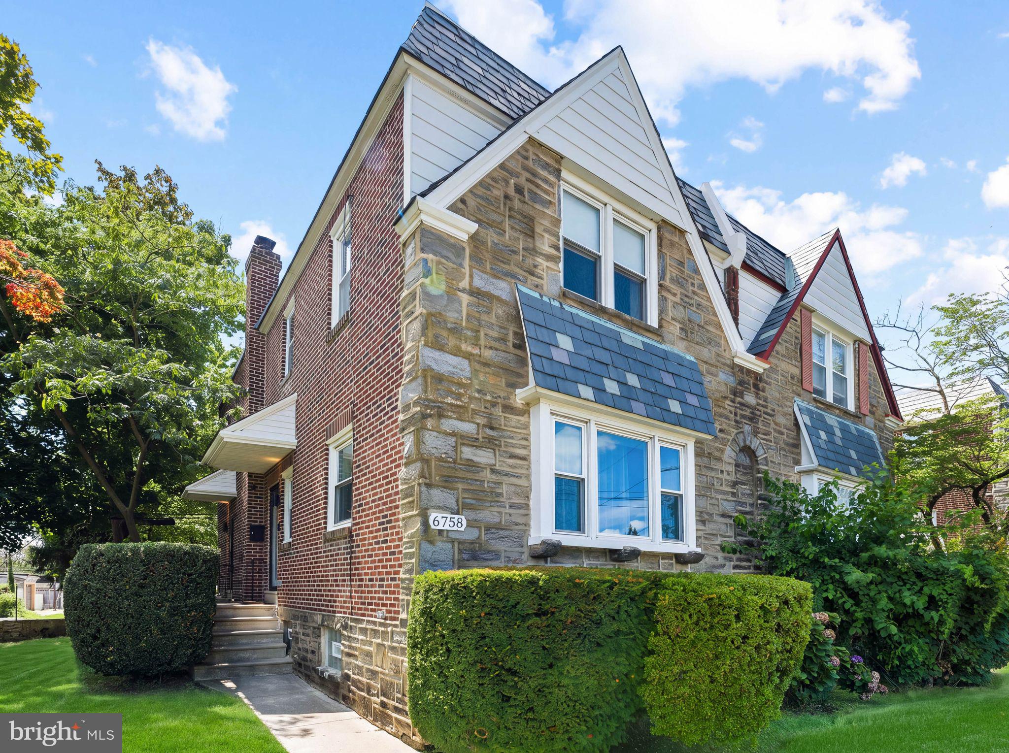 Welcome to 6758 Stenton Ave where timeless Mt. Airy architecture meets sophisticated modern design. 6758 Stenton Avenue is a beautifully renovated stone Tudor Twin Home offering the perfect blend of historic charm and contemporary luxury. Renovated in 2024 and owner-occupied ever since, this meticulously maintained home reflects true pride of ownership and thoughtful craftsmanship throughout. Offering 3 bedrooms, 2 full bathrooms, 2 half bathrooms, and over 2,000 square feet of finished living space, this move-in-ready home is designed for both comfortable everyday living and effortless entertaining.Inside, you'll find a bright, open-concept floor plan featuring wide-plank luxury vinyl flooring, recessed lighting, custom metal railings, and designer finishes. The spacious living and dining areas flow seamlessly into a stunning kitchen complete with quartz countertops, an oversized waterfall island, stainless steel appliances, custom cabinetry, a stylish tile backsplash, and abundant storage. Upstairs, the spacious primary suite features a private ensuite bathroom, while two additional bedrooms and a beautifully updated hall bath complete the second floor. The finished lower level adds valuable living space with a convenient half bathroom, making it ideal for a family room, home office, gym, media room, or guest suite. Outside, enjoy exceptional curb appeal, an attached garage, private rear driveway, and a large backyard perfect for relaxing, entertaining, or play. Ideally located in the heart of Mt. Airy, you'll enjoy convenient access to parks, shopping, dining, public transportation, and major commuter routes while living in one of Northwest Philadelphia's most desirable neighborhoods. Beautifully renovated, meticulously maintained, and truly move-in ready, 6758 Stenton Avenue offers a rare opportunity to own a turnkey home where classic architecture and modern living come together seamlessly. Schedule your private showing today.