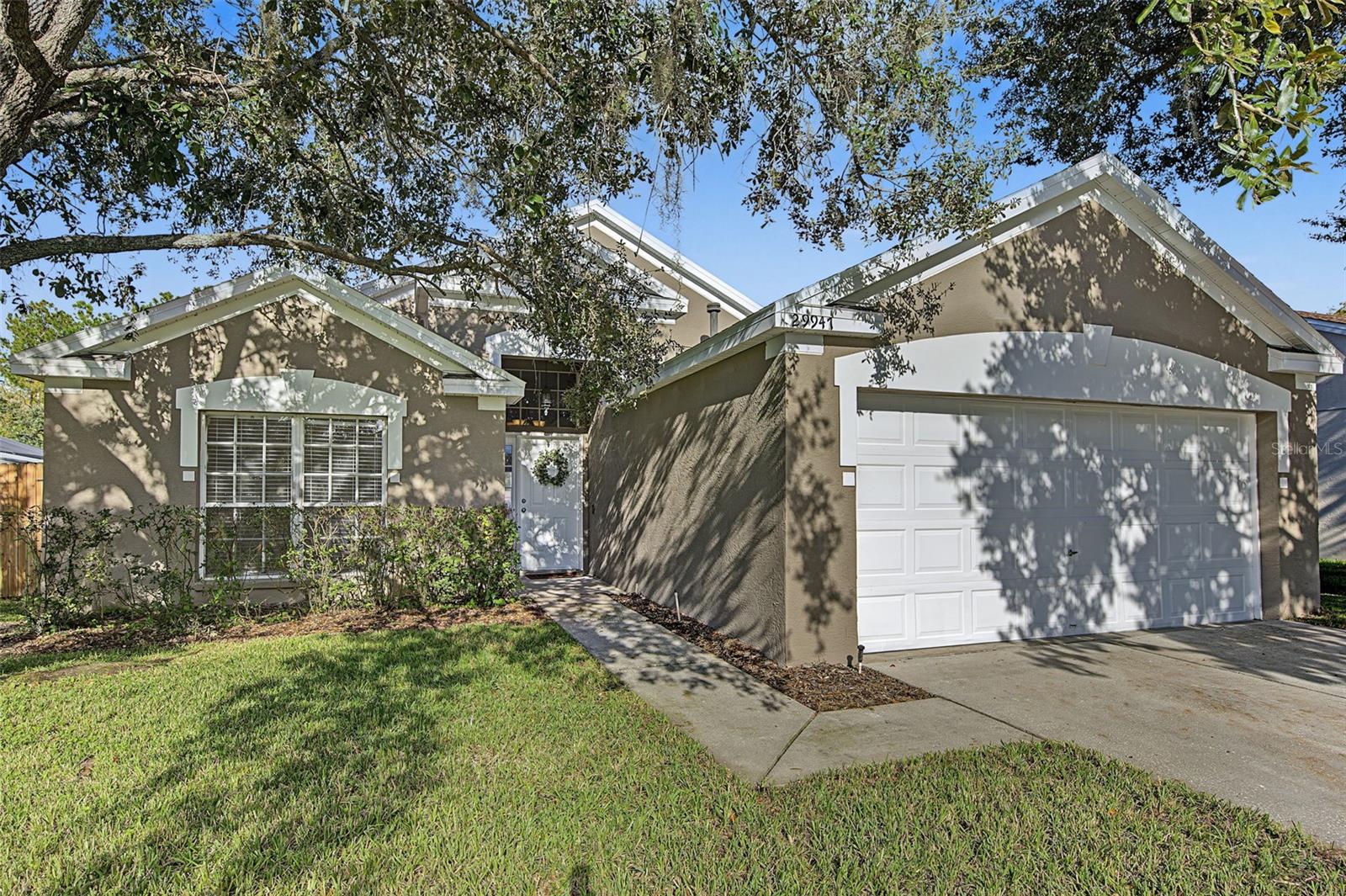 Poolside living with scenic water views in the heart of Wesley Chapel! Located in the established Meadow Pointe community, this 4-bedroom, 2-bathroom home offers a combination of spacious living areas, outdoor amenities, and a beautiful natural backdrop.Step inside to discover soaring ceilings throughout the main living areas, creating an open and airy feel. Freshly painted inside and out, the home features new interior and exterior paint, providing a clean, refreshed appearance throughout. The floor plan offers flexibility for a variety of living arrangements. A new roof installed in 2023 adds another notable improvement to the property.Outside, enjoy your own private Florida retreat featuring a screened-in pool and heated spa, a freshly painted pool deck, and a fenced backyard. With two ponds bordering the property and a conservation area beyond, the outdoor setting offers scenic views and a natural backdrop to enjoy year-round.Conveniently located near The Shops at Wiregrass, Tampa Premium Outlets, and a wide variety of shopping, dining, and entertainment options, this Meadow Pointe home puts much of Wesley Chapel within easy reach.With its 2023 roof, fresh interior and exterior paint, private pool and spa, pond views, conservation backdrop, and convenient location, this property offers a wonderful opportunity to enjoy Florida living! Schedule your showing today!
