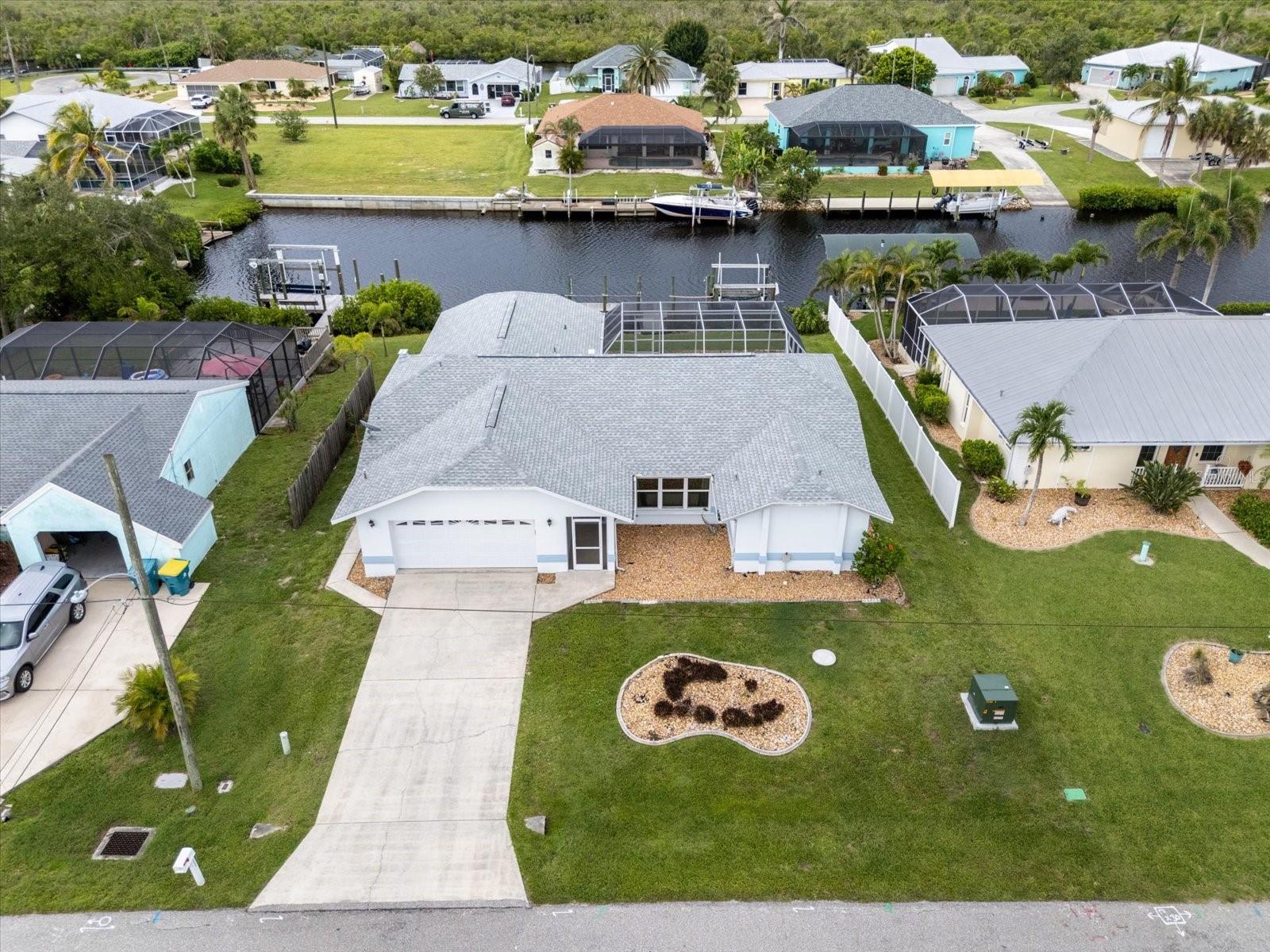 Priced well under market value for a quick sale, this incredible SAILBOAT WATER access POOL home has a short, 10 minute ride to Charlotte Harbor. Boasting 1940 sq.ft with 3 bedrooms, 2 full bathrooms, a Living Room PLUS a Family Room, this home has an UPDATED Kitchen with solid wood cabinetry, QUARTZ countertops, breakfast island, and Stainless Steel appliances.  A formal Dining room, as well as a Dinette, flank the Kitchen for plenty of places to sit and enjoy your meals. Guest bathroom has access to the pool and lanai. There’s an outdoor shower on the pool deck for a quick rinse before or after your swim in the beautiful gunite pool that overlooks the canal. Overside Lanai has a built-in buffet supplied by the pass-through window into kitchen. Amazing floorplan includes access to the Lanai with sliding glass doors in the Primary bedroom, Dining room, Dinette, and a Guest bedroom. Large Laundry room has cabinetry & convenient sink, and entrance is fully screened to keep critters at bay, and fur-babies safe. NEWER 2023 ROOF for your peace of mind in addition to lower insurance rates. 24’ x 6’ Dock is made of TREX composite, with a boat lift at one end, leaving plenty of room for a sailboat to dock! HURRICANE PROTECTION with shutters, including accordion style across the Lanai. Lovingly care for by owners over the past 23 years, don’t miss out on this fabulous, priced to sell, Gulf access POOL home!