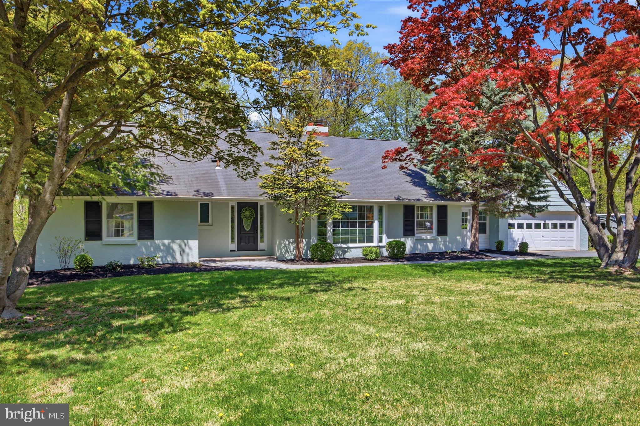 Set on nearly two private acres within the sought after Downingtown Area School District, this move in ready home offers the space and flexibility that are increasingly hard to find in Downingtown. Surrounded by mature trees and a peaceful, serene neighborhood, the property provides a rare opportunity to enjoy both privacy and convenience.The home is designed for easy single level living, featuring a spacious living room with a wood burning fireplace, a formal dining area, and a bright eat in kitchen. The kitchen features a central island, ample storage, and sliding doors that open directly to the expansive backyard. The rear deck overlooks the level lot and wooded surroundings, creating an ideal setting for everyday living and entertaining.Three comfortable bedrooms are located on the main level, including a primary suite with three closets and a private full bath, along with a well appointed hall bathroom. The lower level adds even more versatility with a partially finished space that is perfect for a media room, playroom, or additional living area, plus a separate 4th bedroom or office for added privacy. A large unfinished section presents incredible potential, complete with walk out access, a half bath, and a dedicated laundry area.A breezeway just off the kitchen offers a space for grilling, a  mudroom, or cozy sitting space. The oversized two car garage provides ample room for vehicles, hobbies, and additional storage.Lovingly maintained over the years, with a new septic tank installed in March 2026 and a successful water test already completed, this home offers both peace of mind and lasting value in a truly desirable setting.